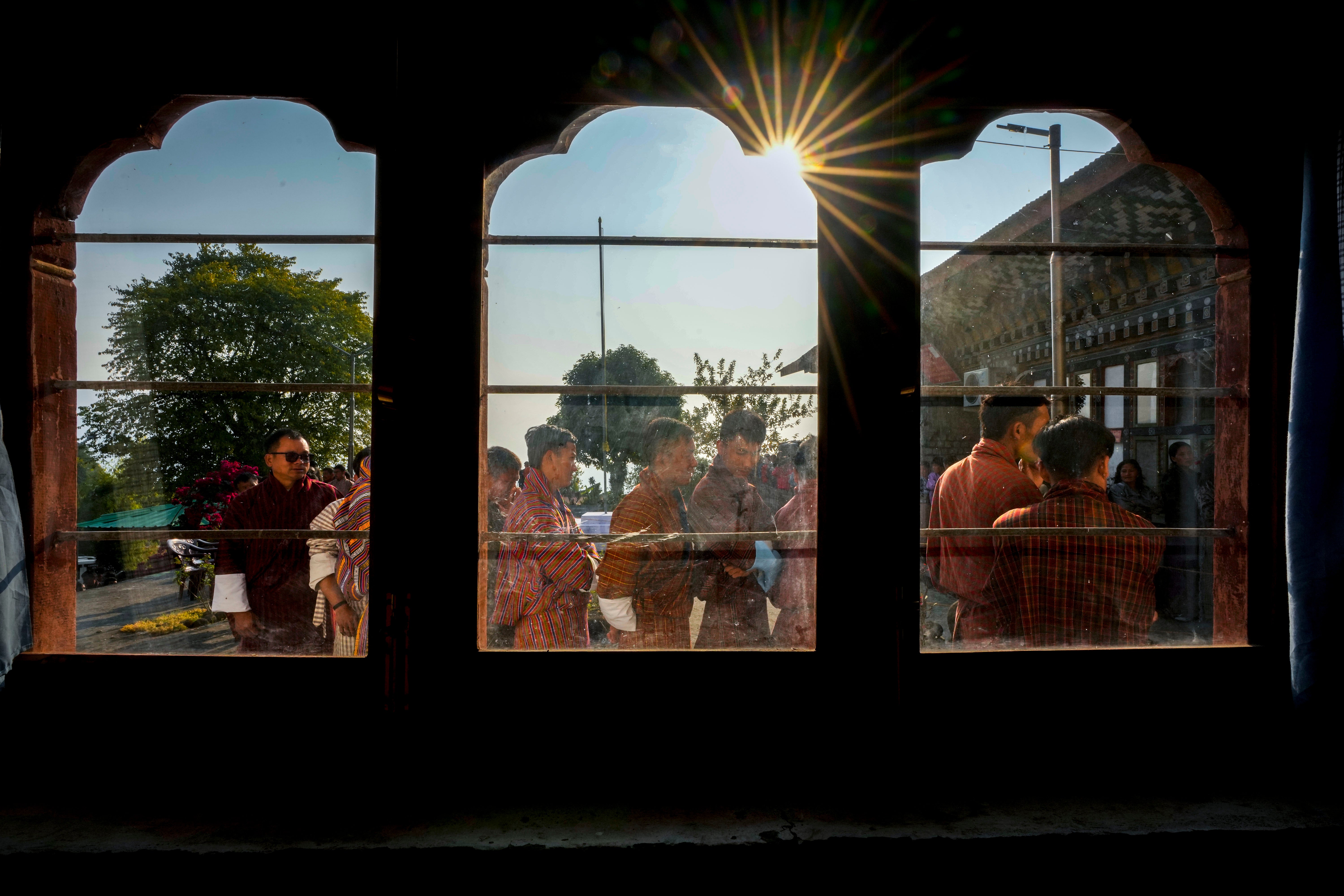 Bhutanese people in traditional attire queue up to cast their votes in the national elections in Deothang, Bhutan