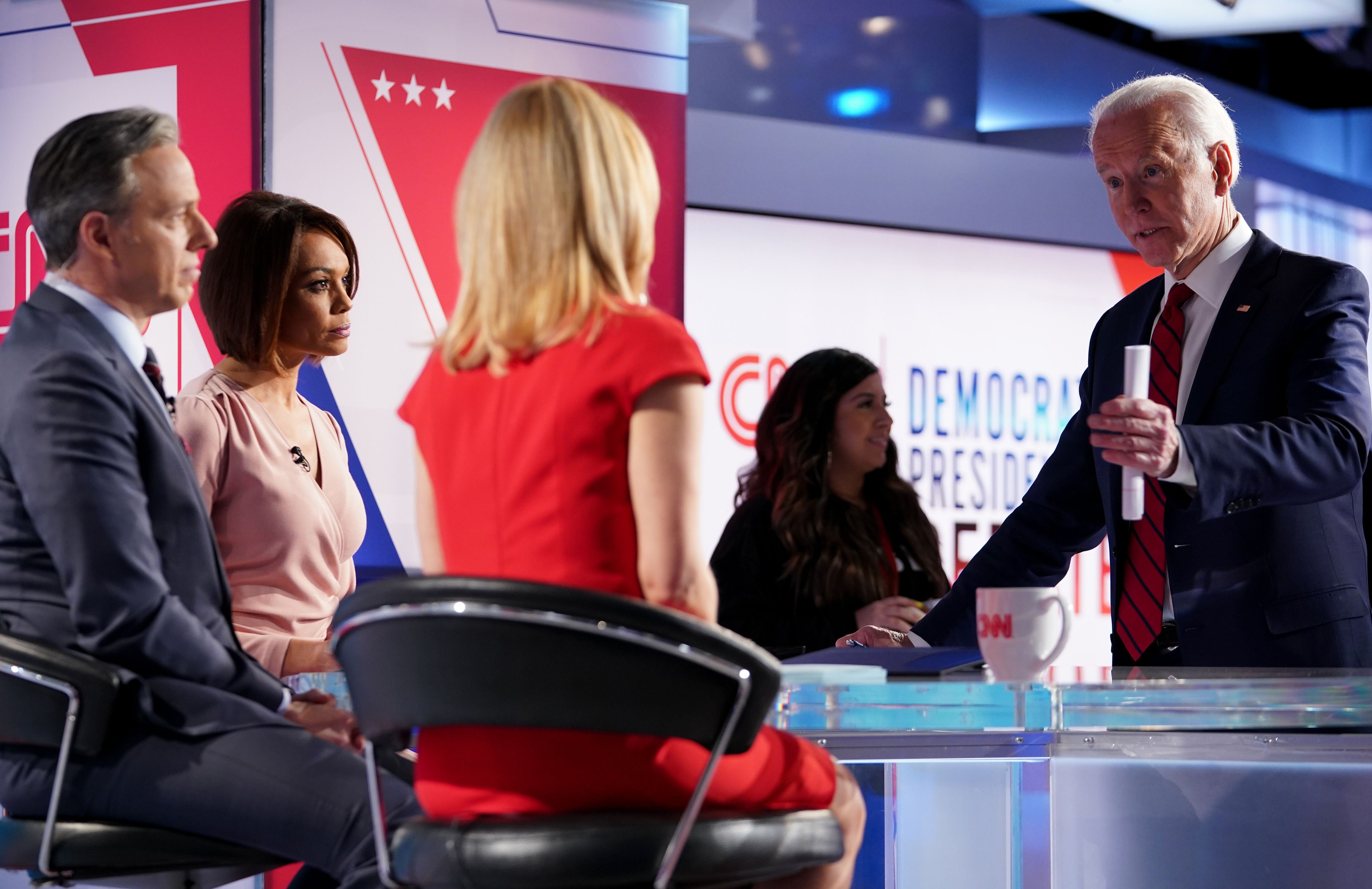 Democratic presidential hopeful former US vice president Joe Biden talks with moderators (L-R) Univision's journalist Ilia Calderon, CNN chief Washington correspondent Jake Tapper and CNN political correspondent Dana Bash at the end of the 11th Democratic Party 2020 presidential debate in a CNN Washington Bureau studio in Washington, DC on March 15, 2020