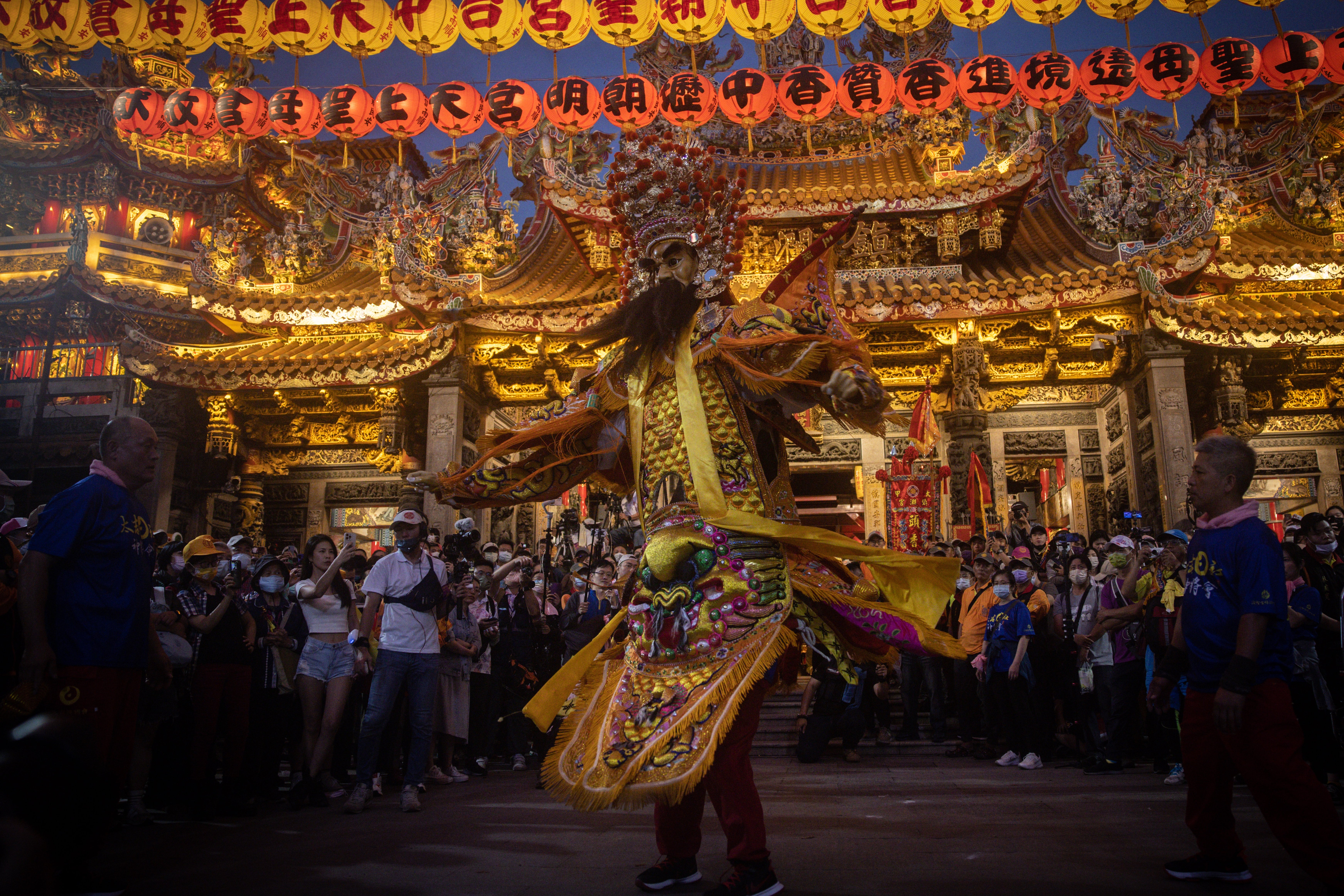 People take part during a ceremony to honour sea goddess Mazu, in Taichung, Taiwan, last year