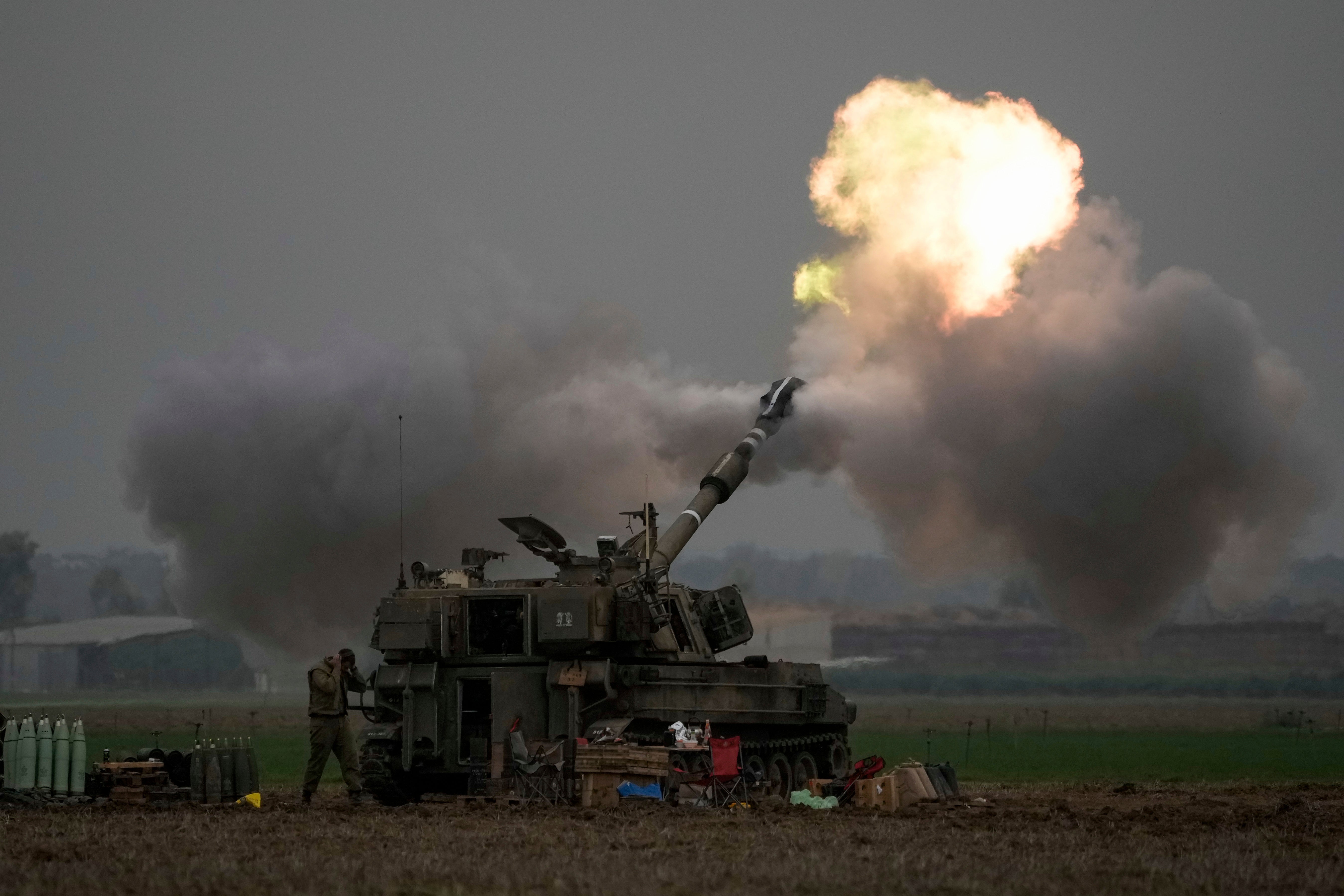 An Israeli mobile artillery unit fires a shell from southern Israel towards the Gaza Strip