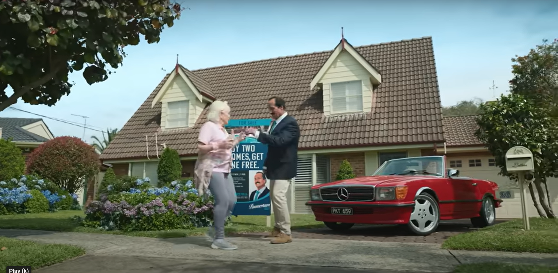 The older woman is handed a key to a new home