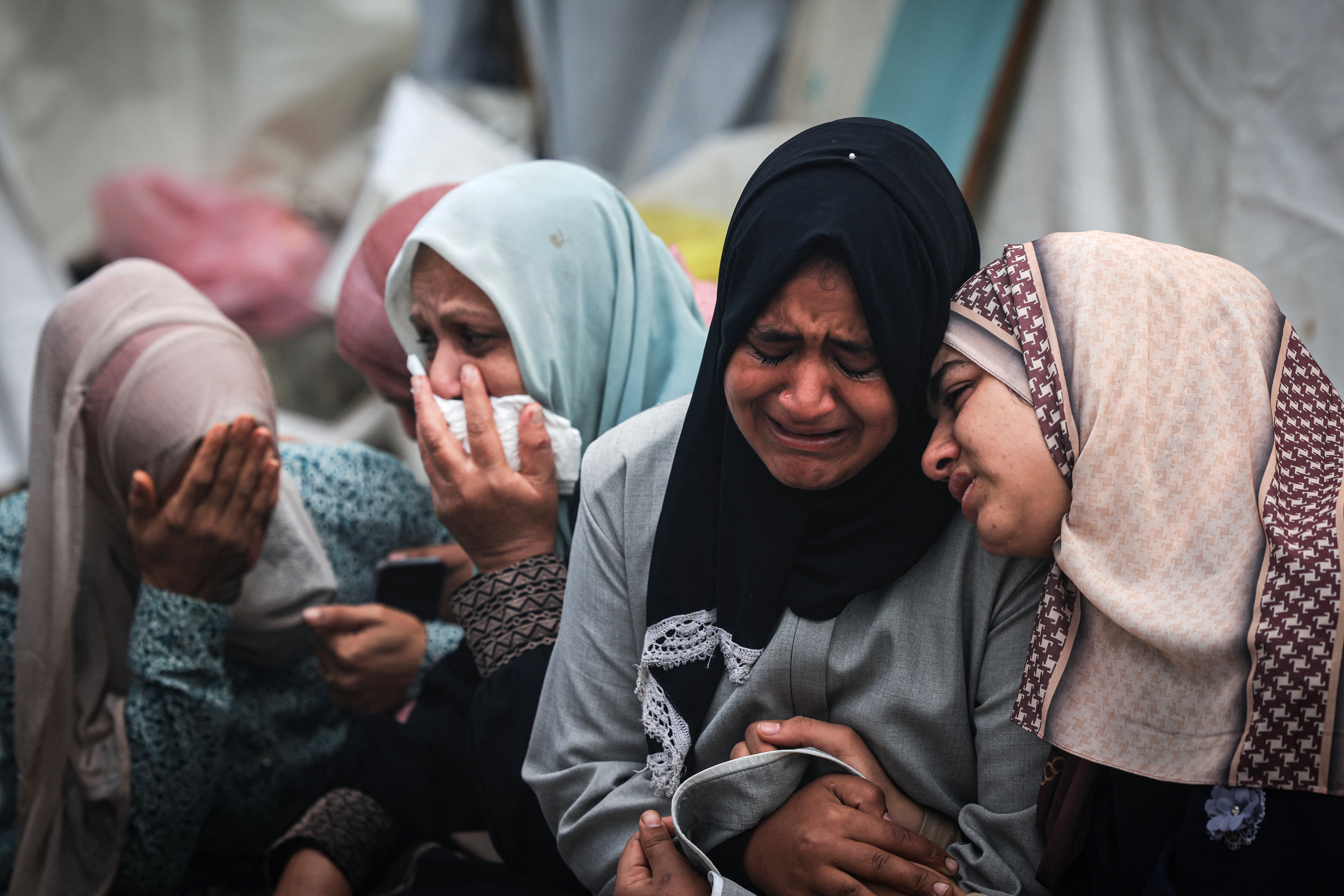 Palestinian families outside al-Aqsa Hospital in central Gaza