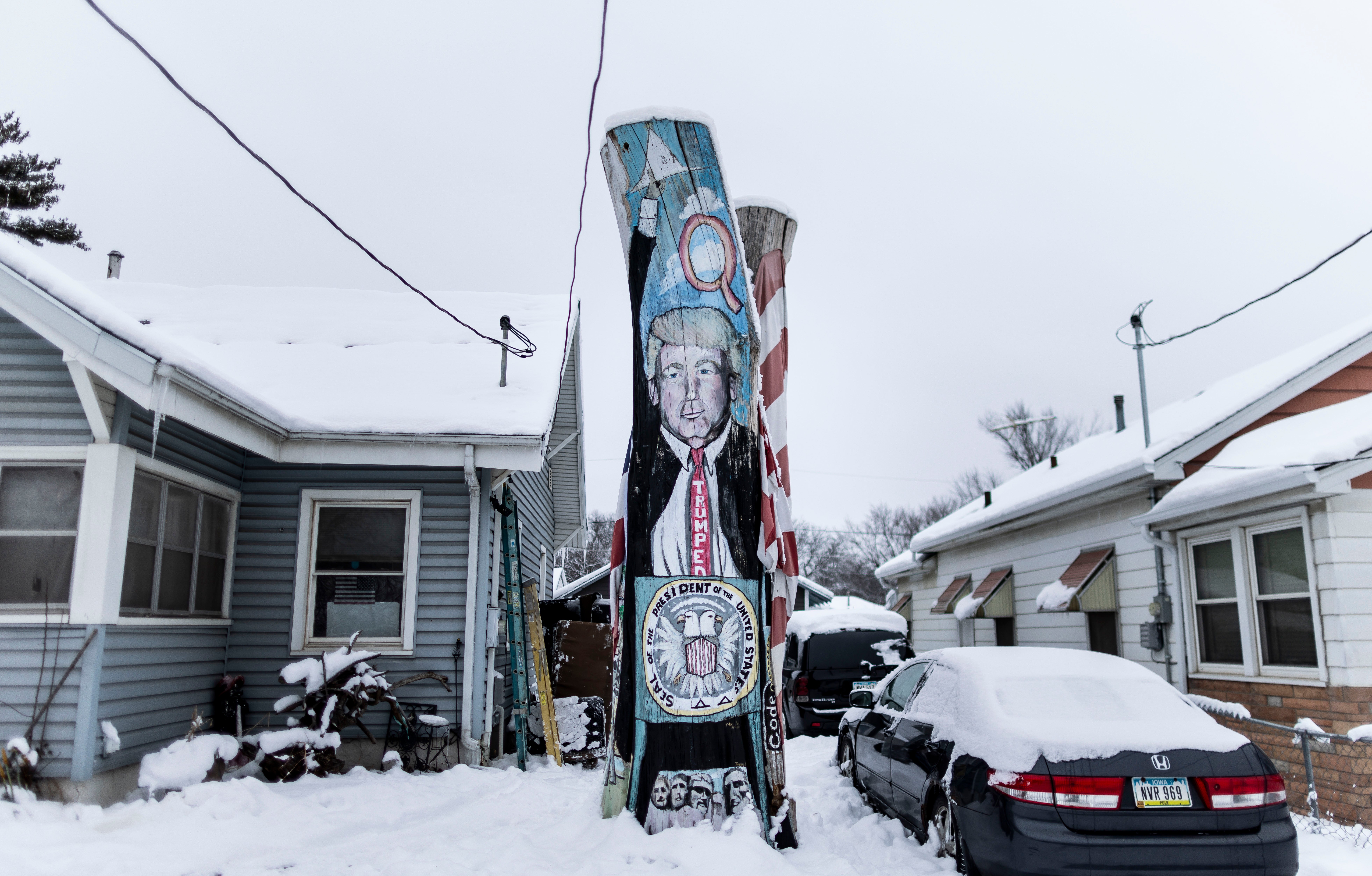 The remains of a tree painted with an image of former President Donald Trump in Des Moines, Iowa, USA, 11 January 2024