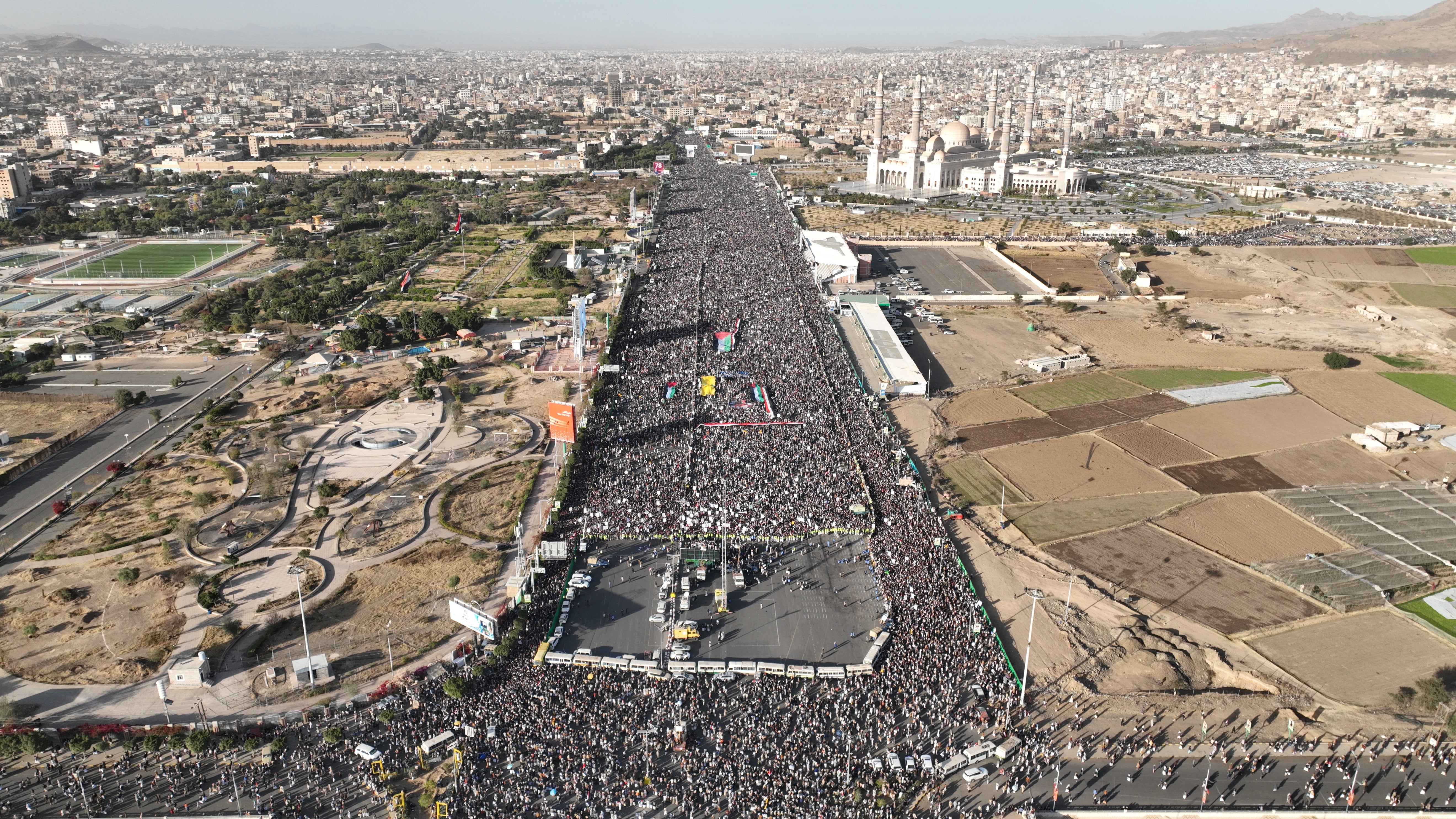 A drone view as supporters of the Houthi movement rally to denounce air strikes launched by the US and Britain on Houthi targets, in Sanaa, Yemen