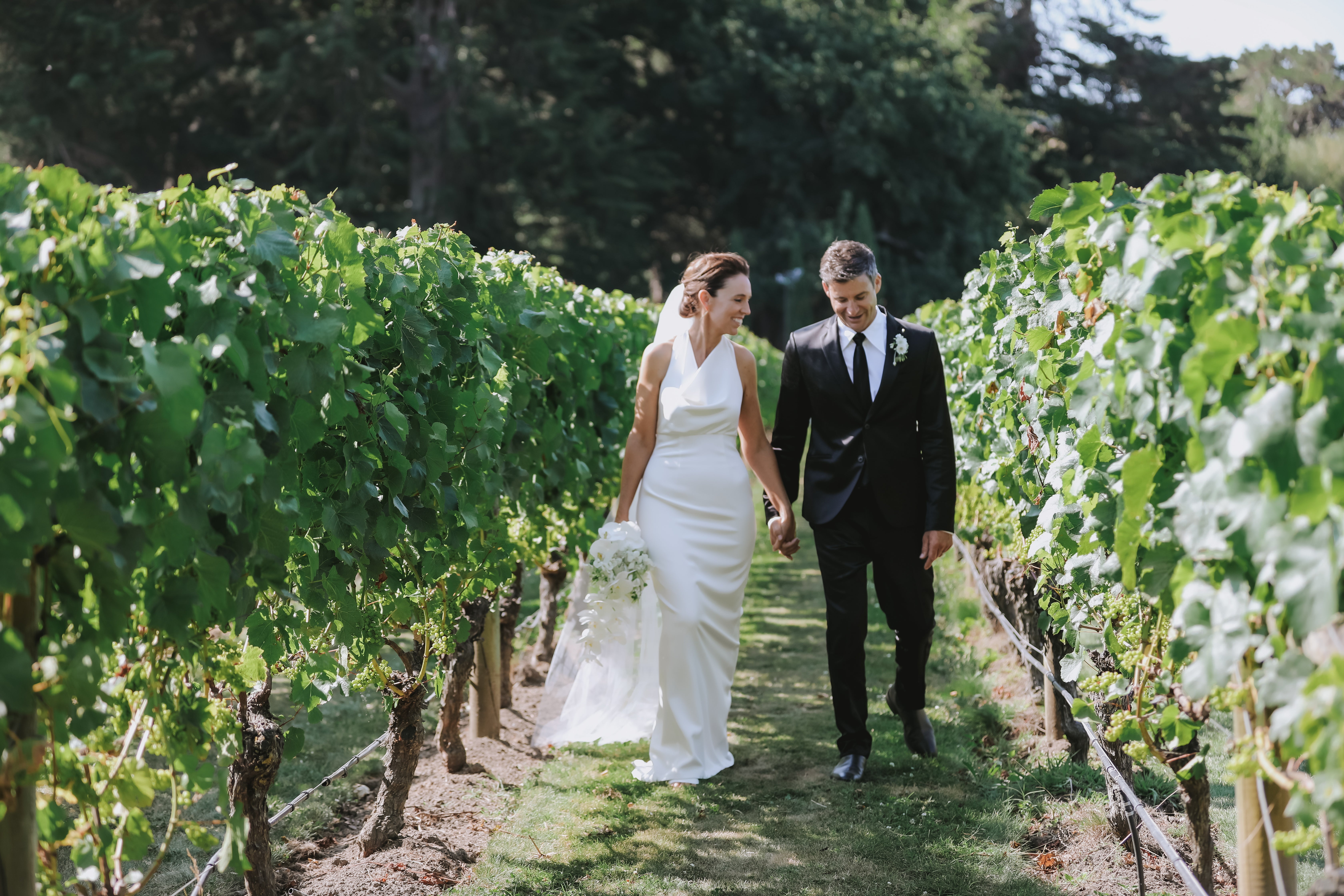 Ms Ardern wore a fitted ivory dress and a long veil by designer Juliette Hogan