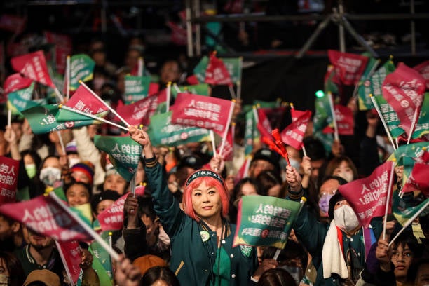 Supporters of Taiwan’s vice president and president-elect from the Democratic Progressive Party (DPP) Lai Ching-te (C) wait for him to speak at the party’s headquarters on 13 January 2024 in Taipei, Taiwan