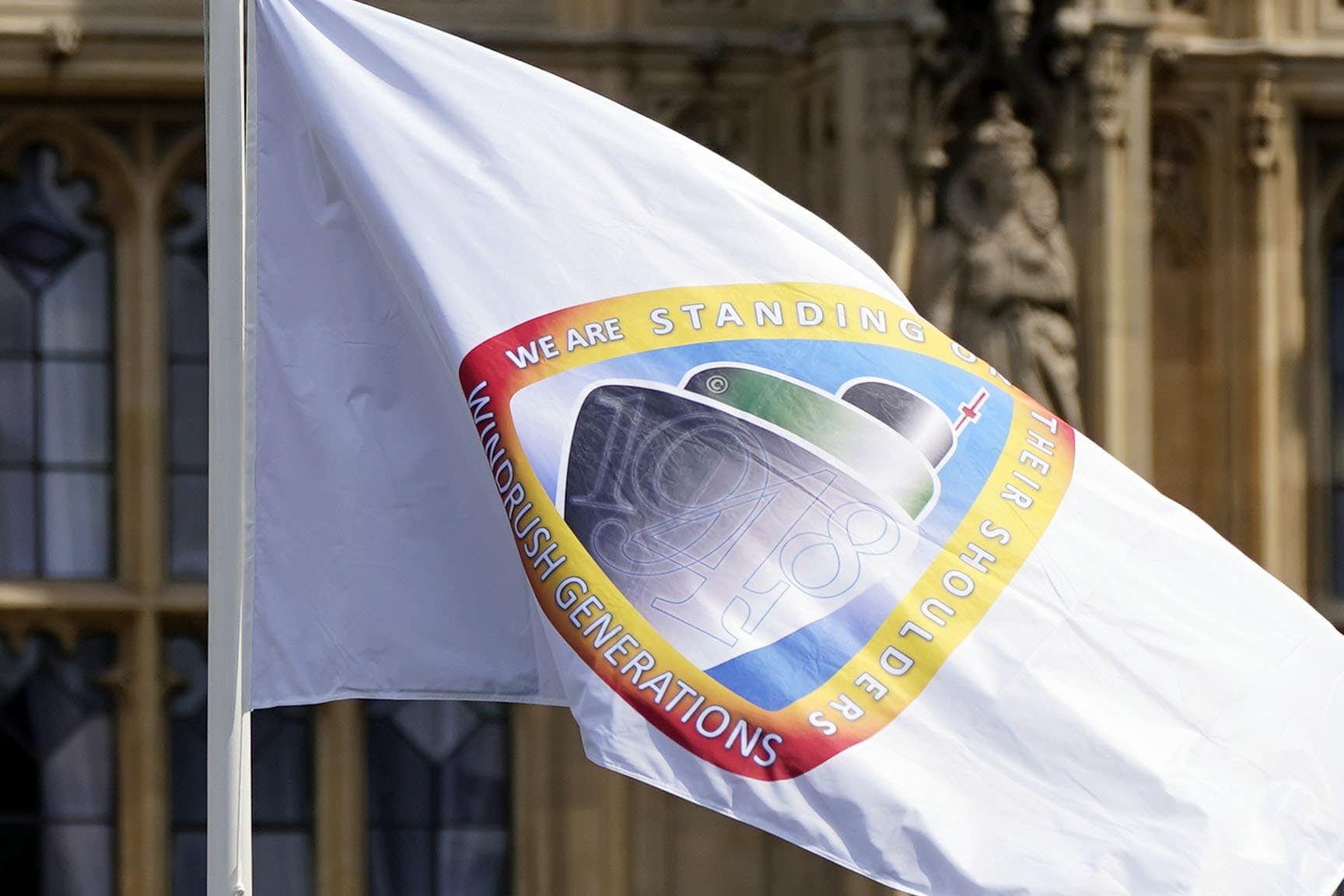 The Windrush flag was flown outside Parliament on the 75th anniversary of the ship’s arrival to Britain, but campaigners said compensation for victims of the scandal has been far too slowly paid out (Aaron Chown/PA)