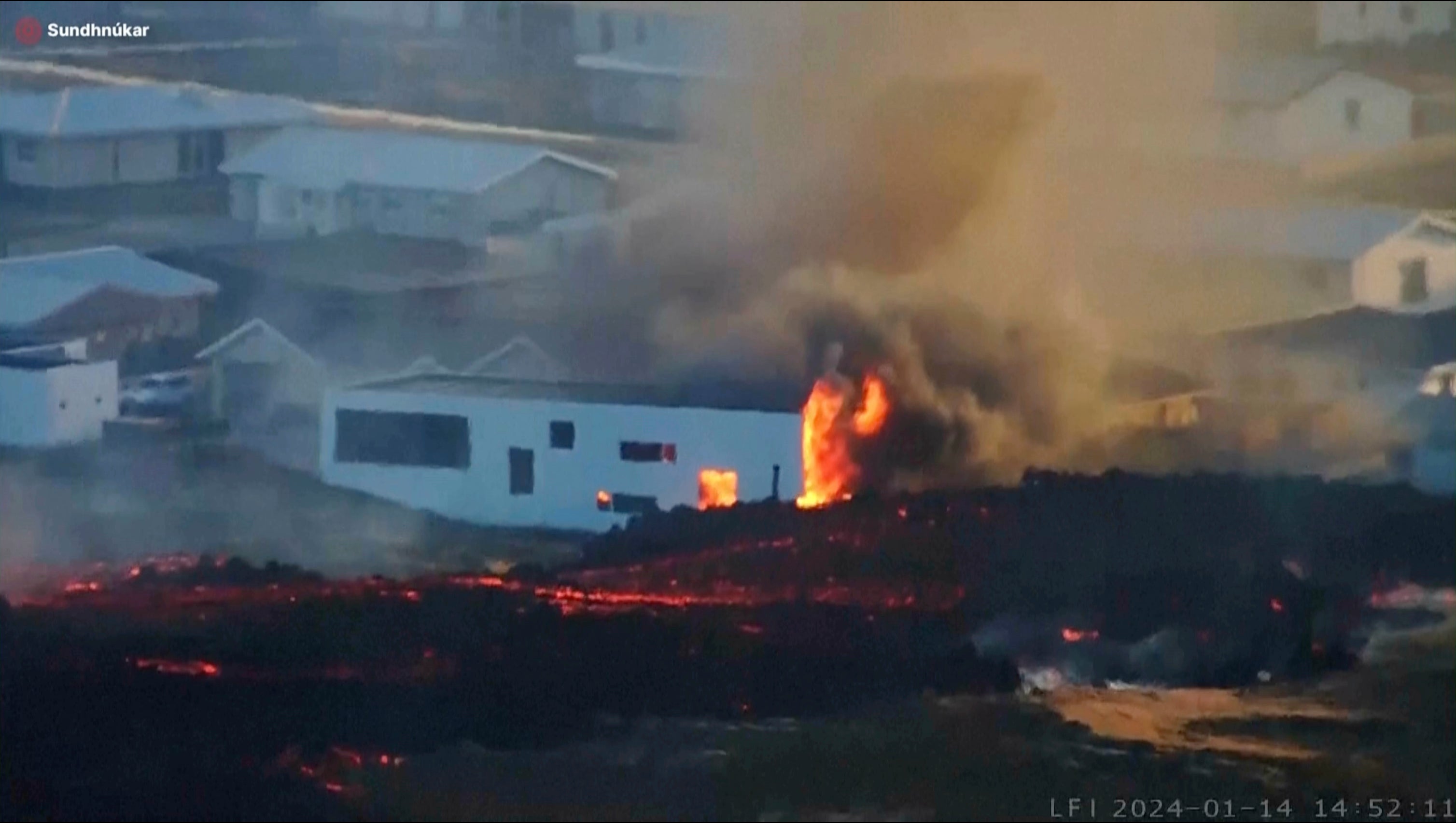 Lava from an erupting volcano in Iceland consuming a building near the town of Grindavik, Iceland, on Sunday