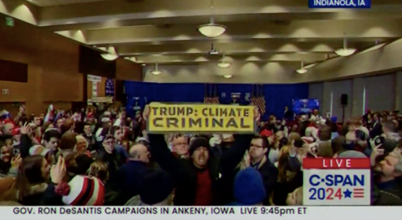 A protestor accused Mr Trump of being a ‘climate criminal’ at a rally in Iowa on Sunday