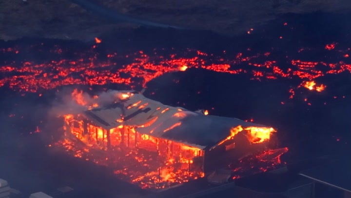 House burns down as lava river surrounds building