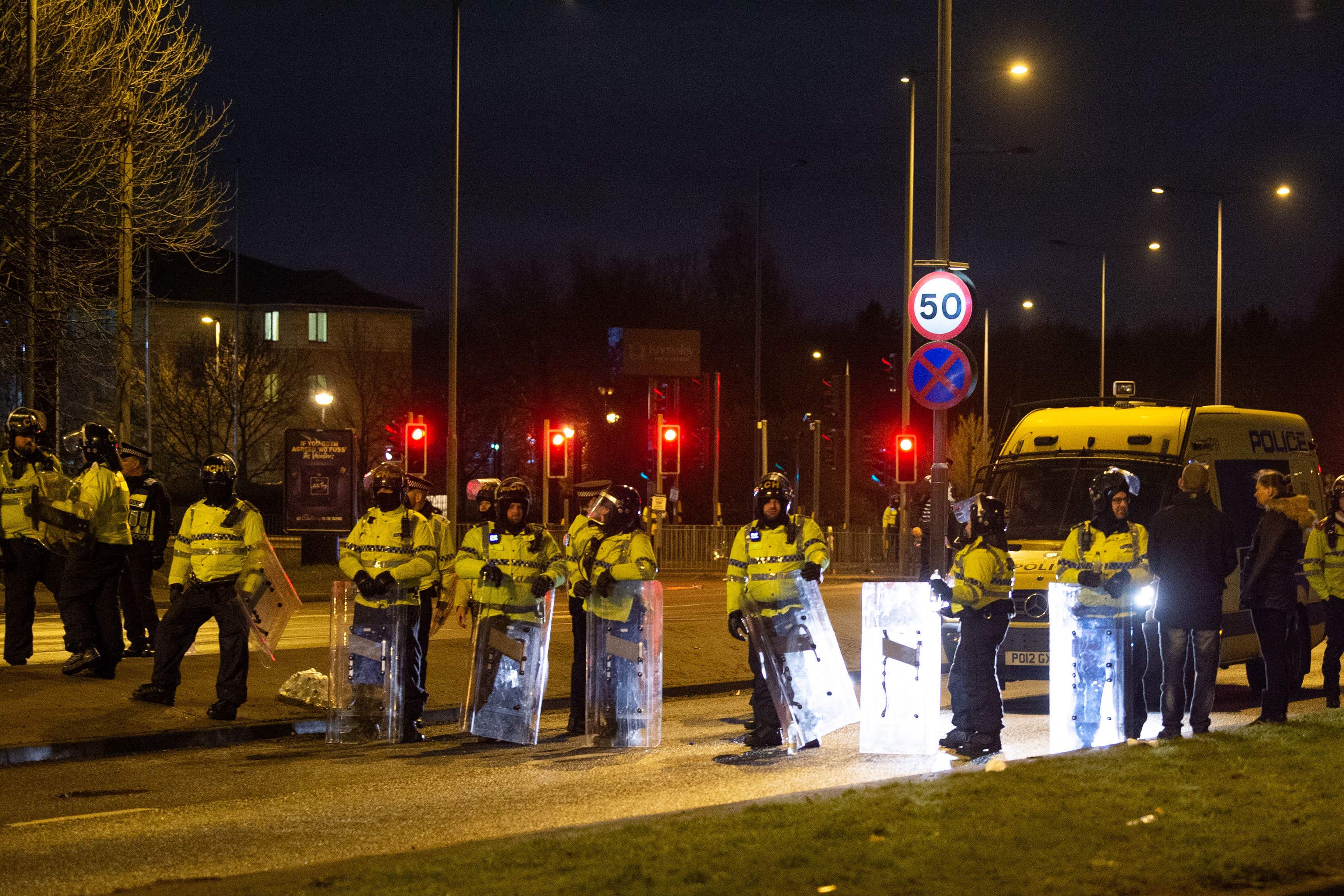 Police in riot gear after a demonstration outside the Suites Hotel in Knowsley, Merseyside (Peter Powell/PA)