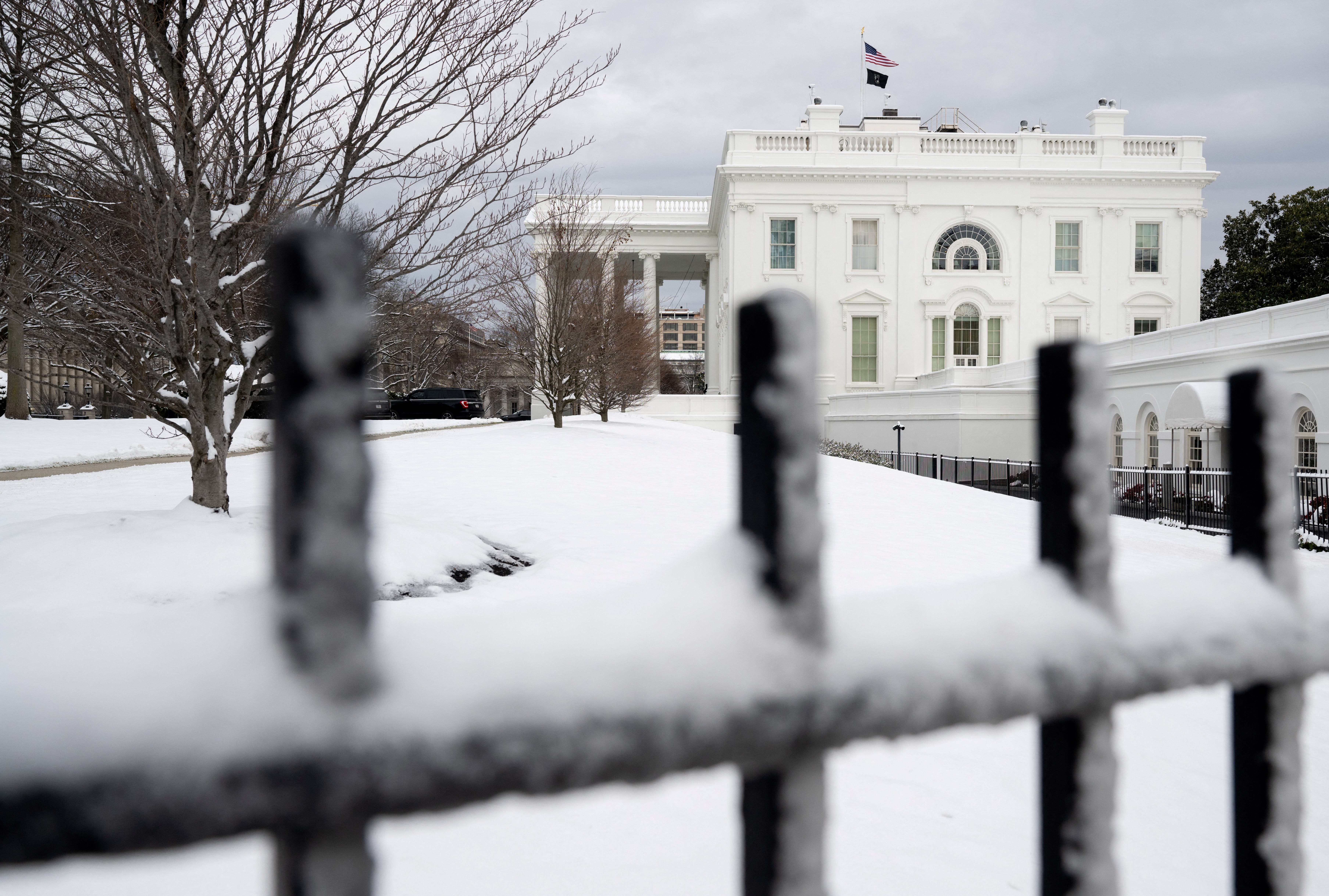 Snow blankets the North Lawn of the White House in Washington, DC, on January 16