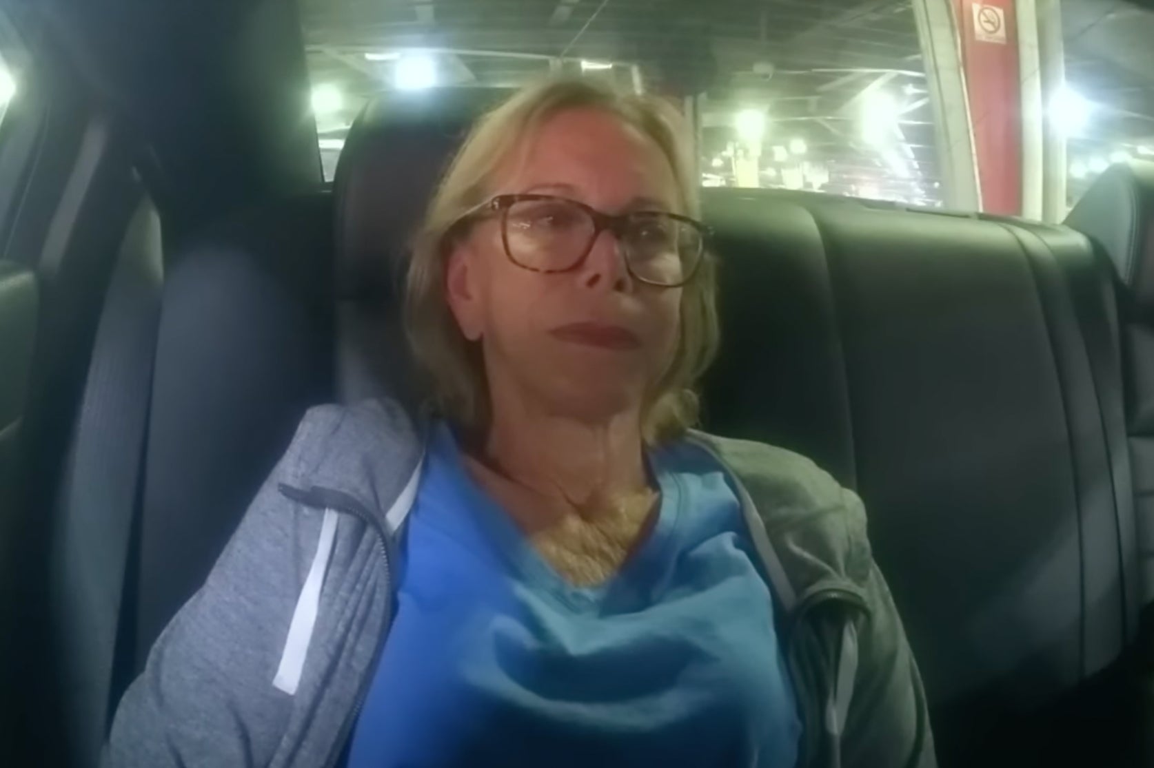 Donna Adelson sits emotionless in the backseat of a patrol car when taken into custody