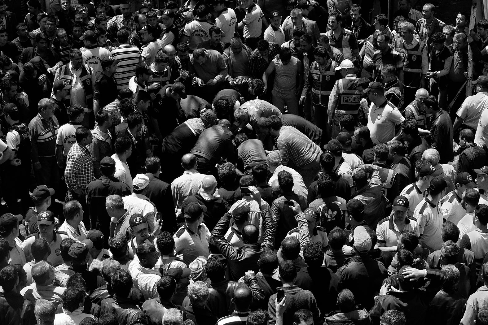 People gathered as security forces collect bodies after deadly twin car bombings that killed 53 and injured 146 in Reyhanli, a Turkish town on the Syrian border, on 11 May 2013