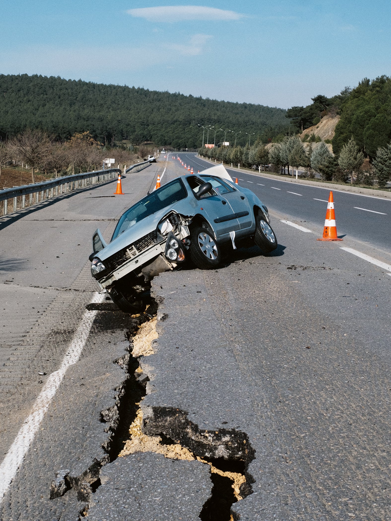 A car seen damaged on the broken highway road during the powerful earthquake on 8 February 2023