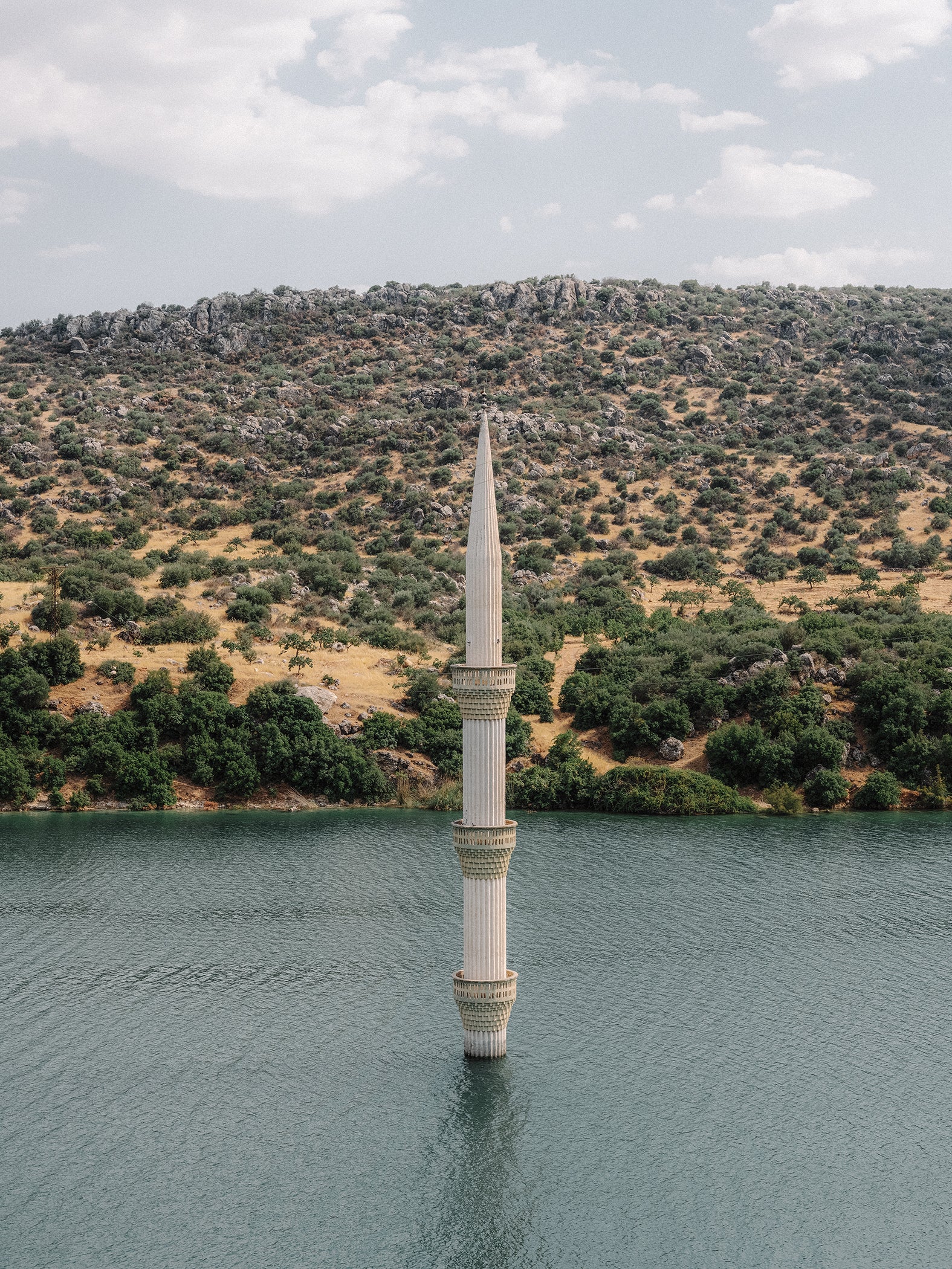 The minaret of a sunken mosque emerges from the reservoir of the Birecik dam in Gaziantep. For several decades now, dozens of villages and towns have disappeared under water as a result of the numerous hydroelectric power plant projects of successive governments under the Southeast Anatolia Project