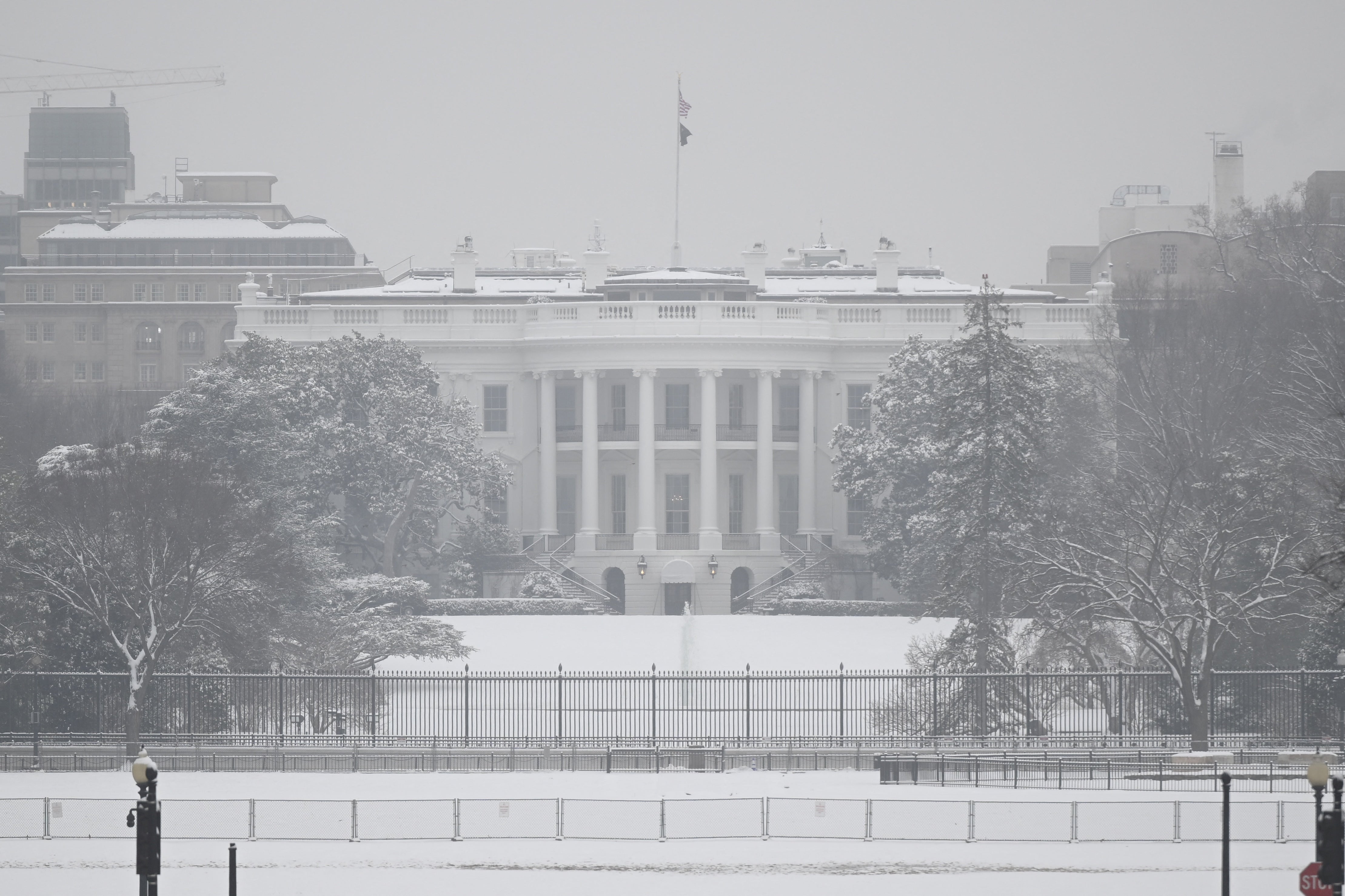 The White House is seen on a snowy day in Washington, DC, on January 16