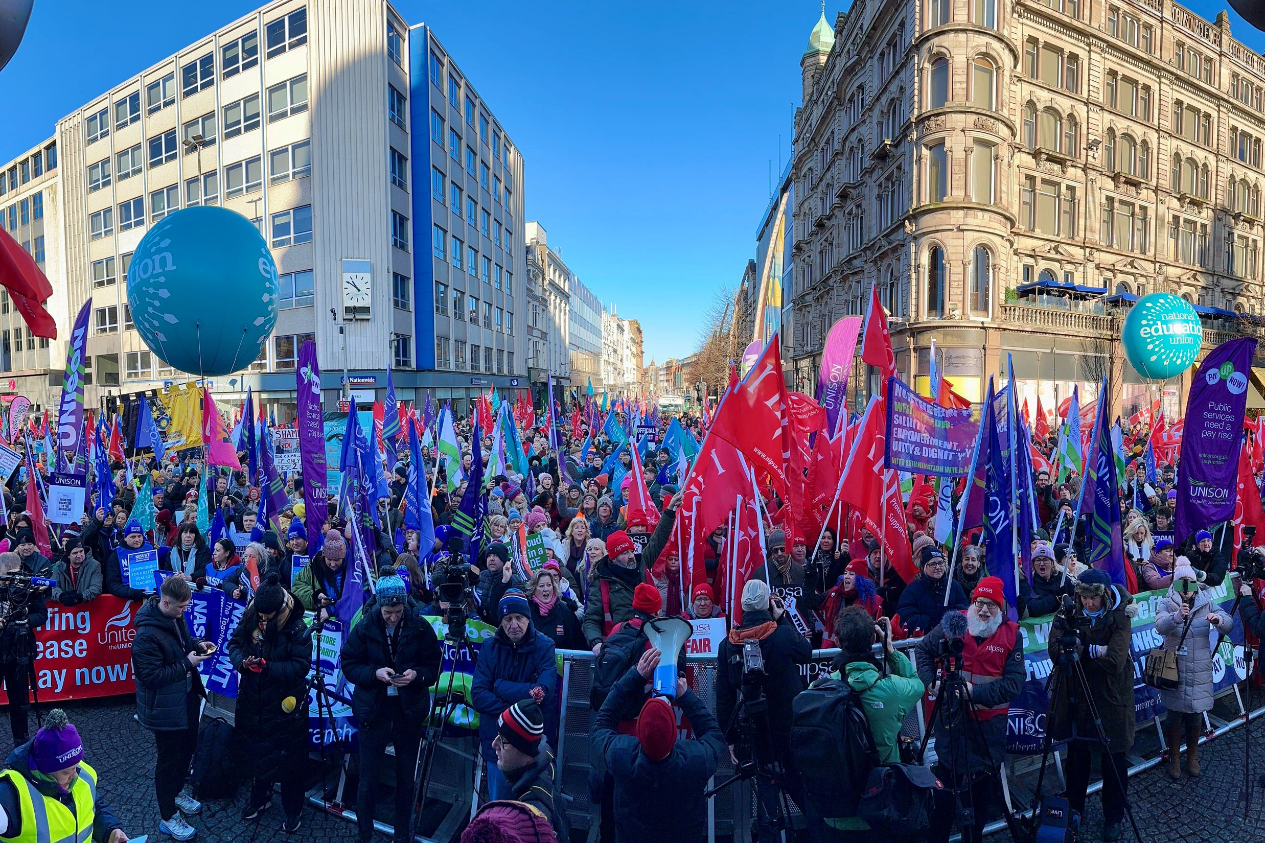 Public sector workers take part in a rally at Belfast City Hall (Liam McBurney/PA)