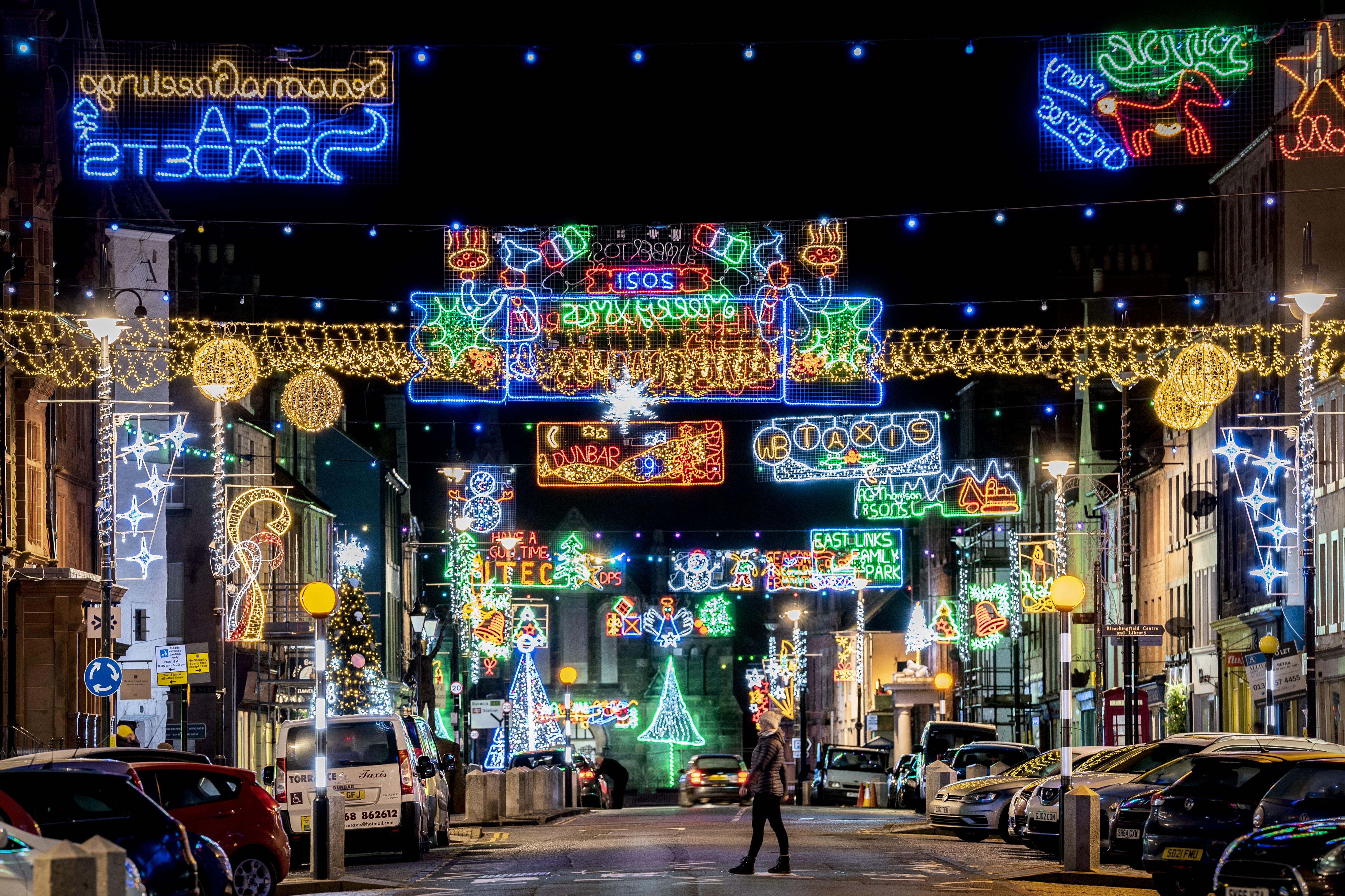 A lone person walks down the High Street in Dunbar, East Lothian lit for Christmas. (Jane Barlow/PA)