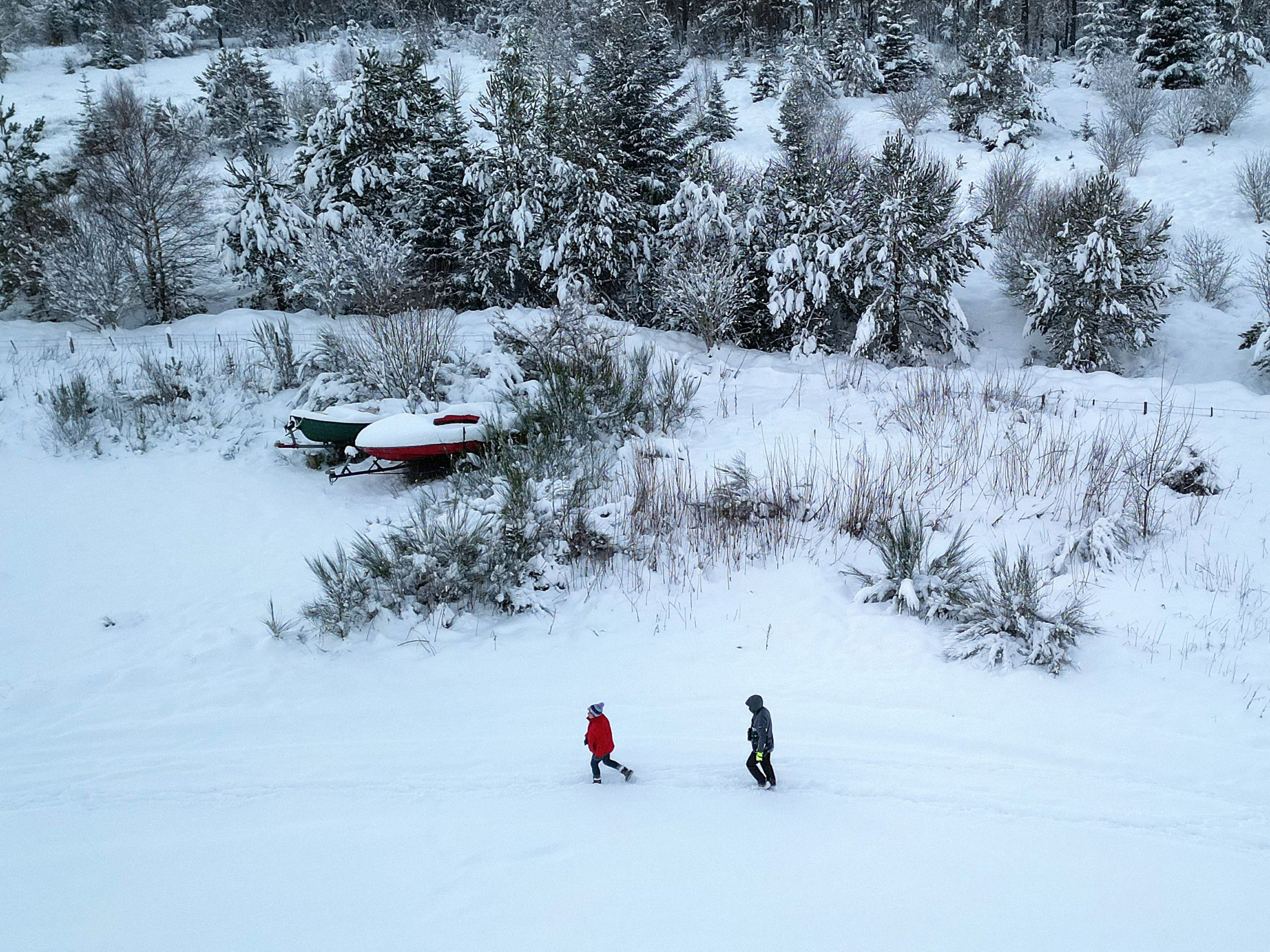 Members of the public walk in the snow as the met office issued weather alerts
