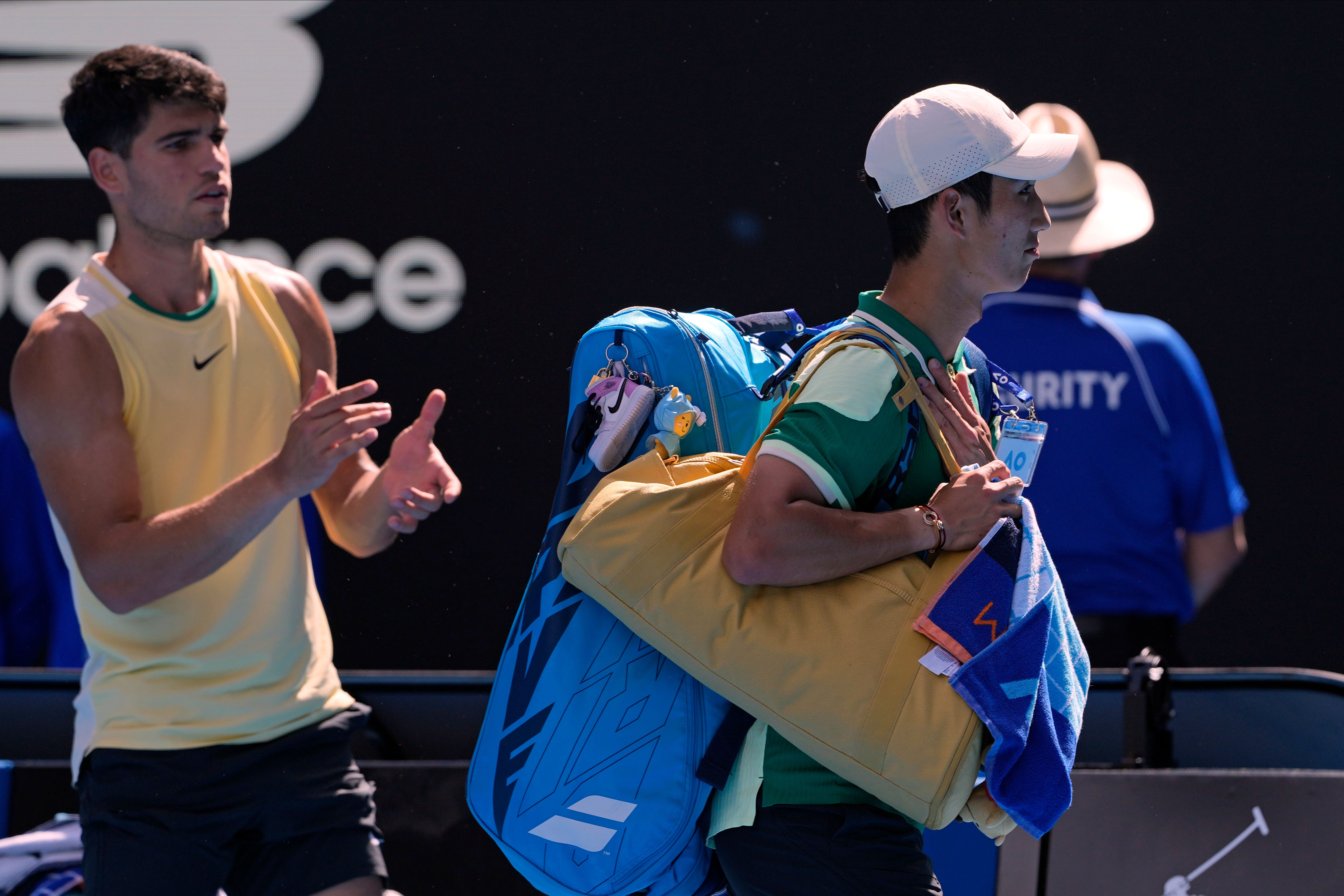 Carlos Alcaraz, left, applauds Shang Juncheng as he walks off (Andy Wong/AP)