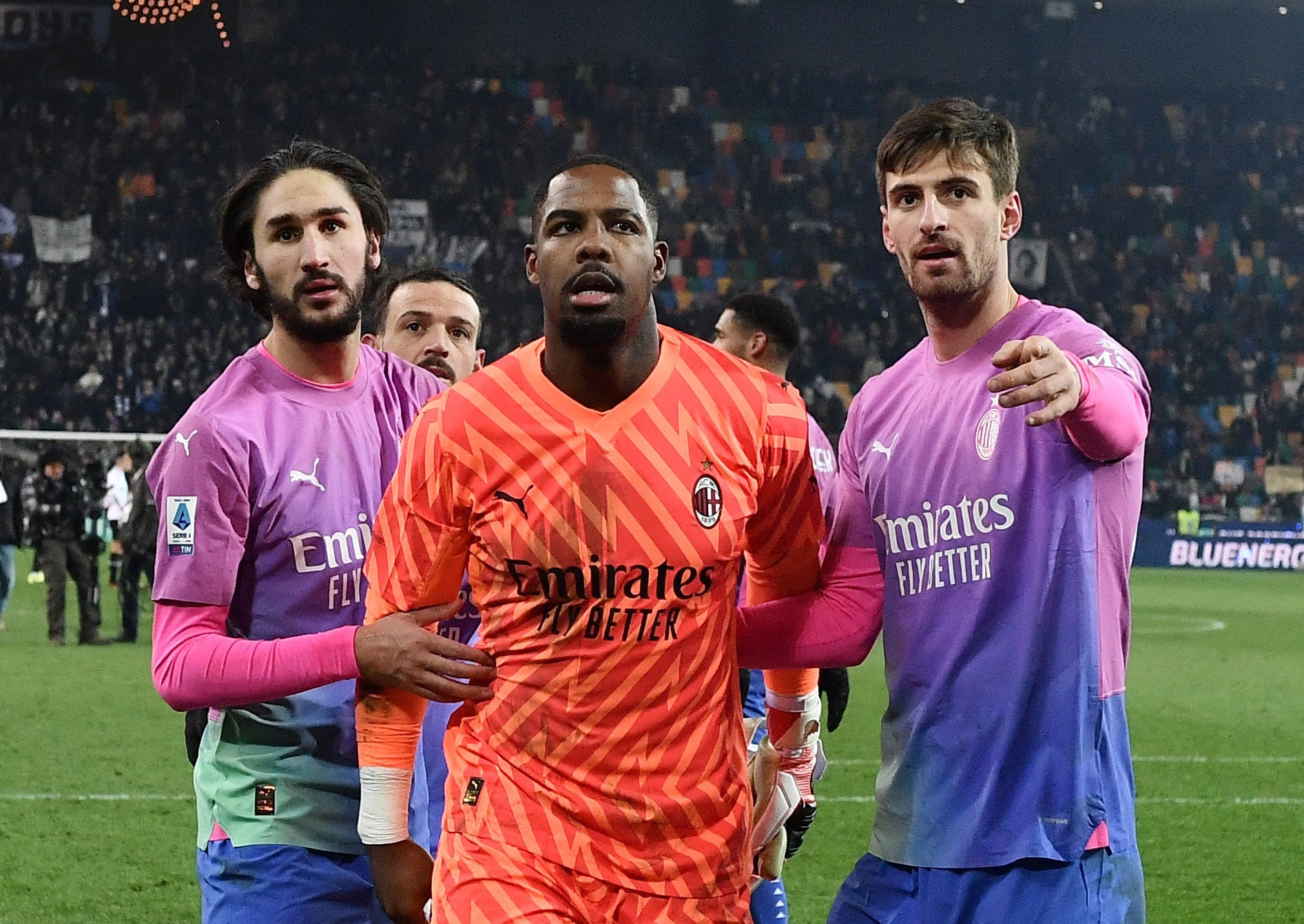 Mike Maignan, Yacine Adli and Matteo Gabbia celebrate after the match in which Maignan walked off the pitch after alleged racist abuse from supporters