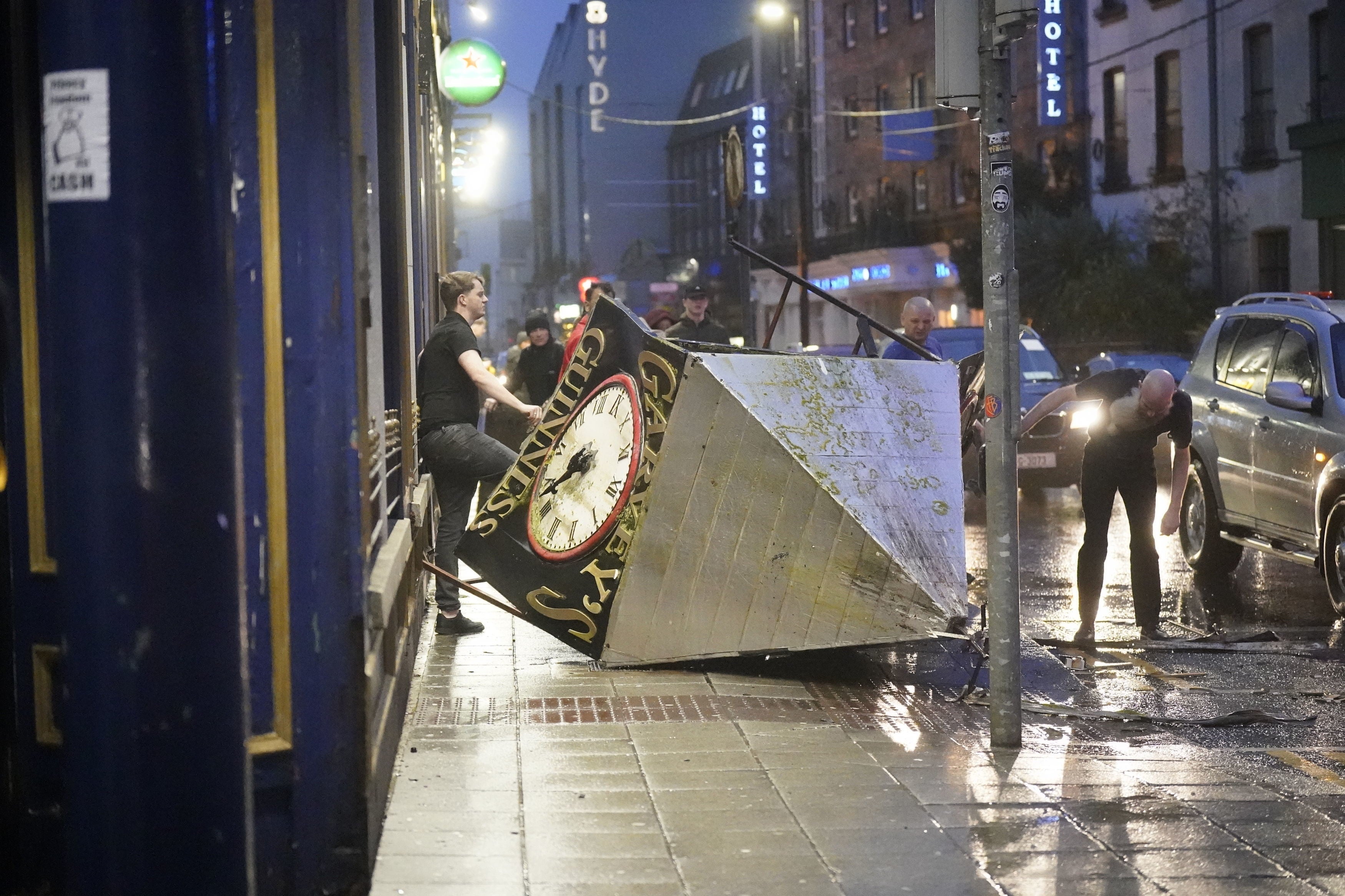 A clock tower falls to the ground in Eyre Square, Galway, during the strong winds