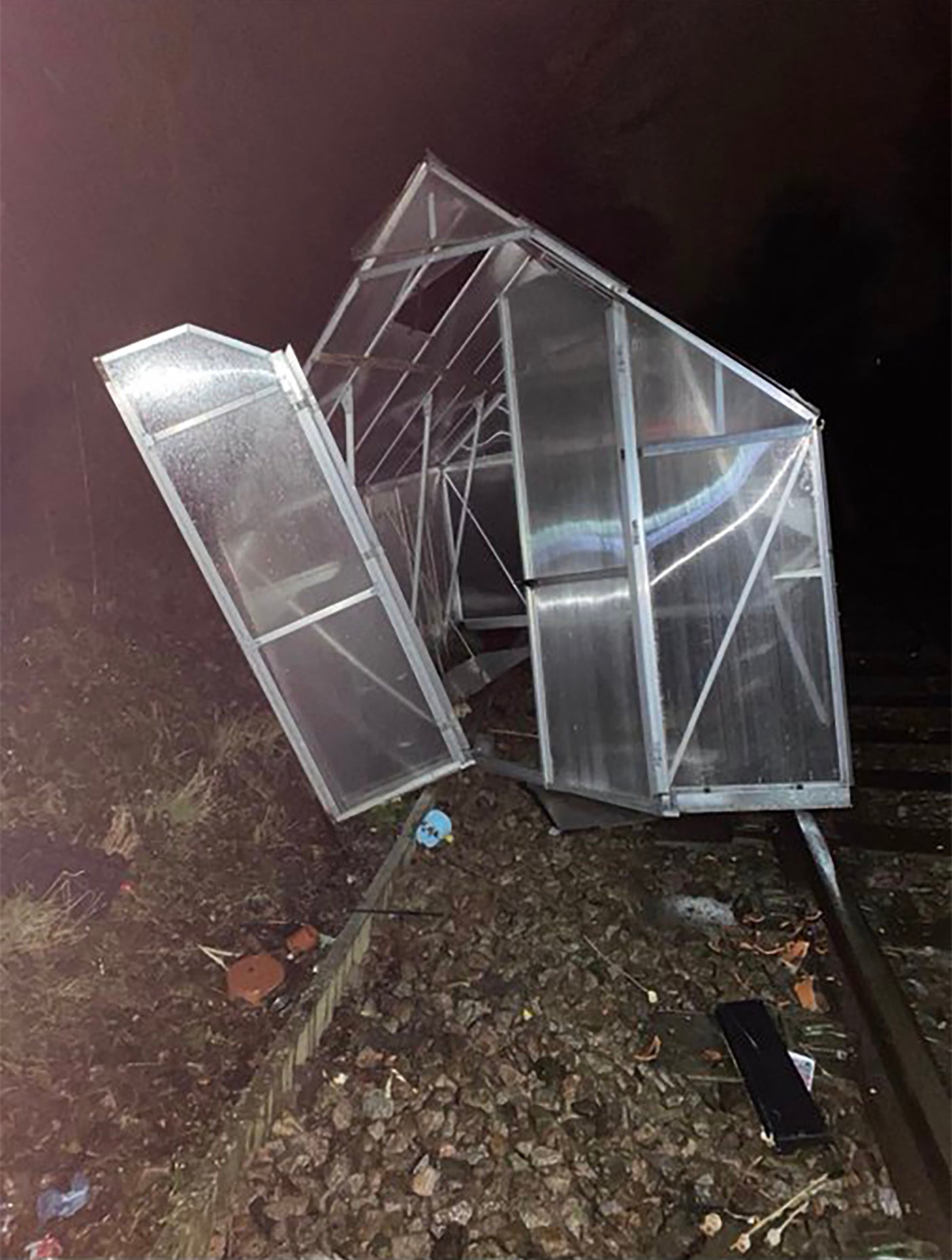 A greenhouse thrown around in Storm Isha winds landed on a rail line