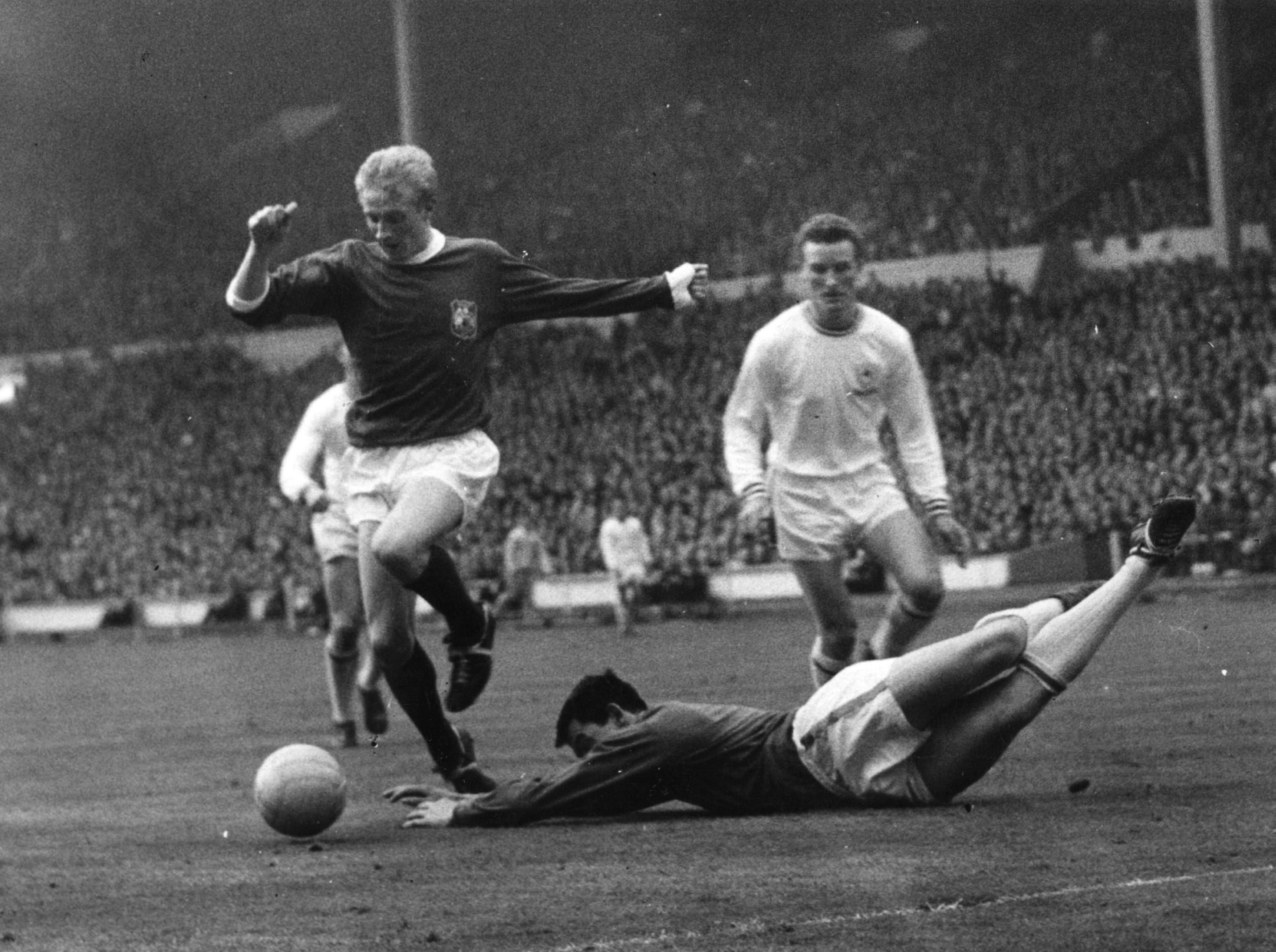 Law dribbles around Leicester goalkeeper Gordon Banks during the 1963 FA Cup final at Wembley