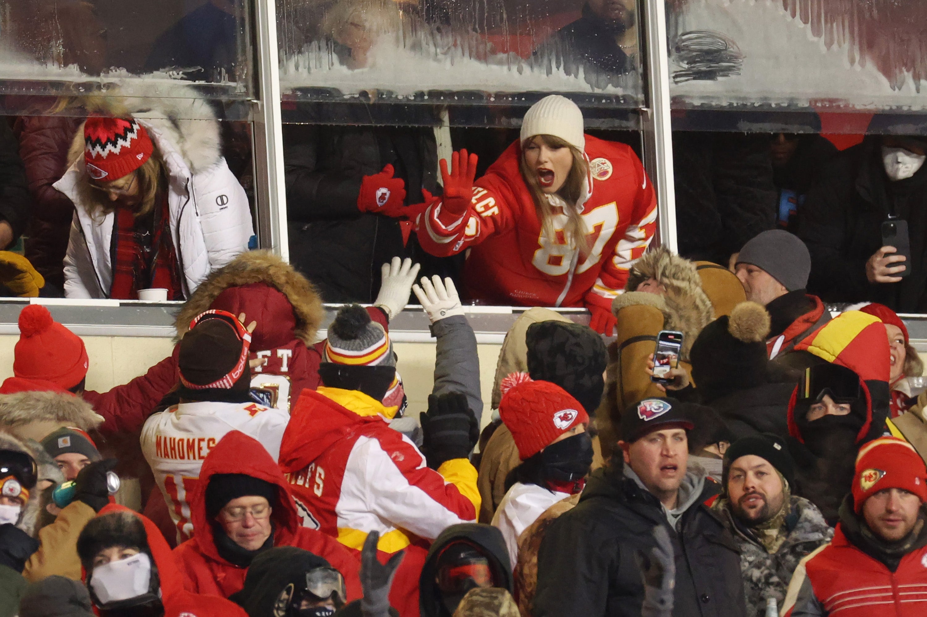 Taylor Swift celebrates with fans during the Kansas City Chiefs game against the Miami Dolphins, 13 January 2024