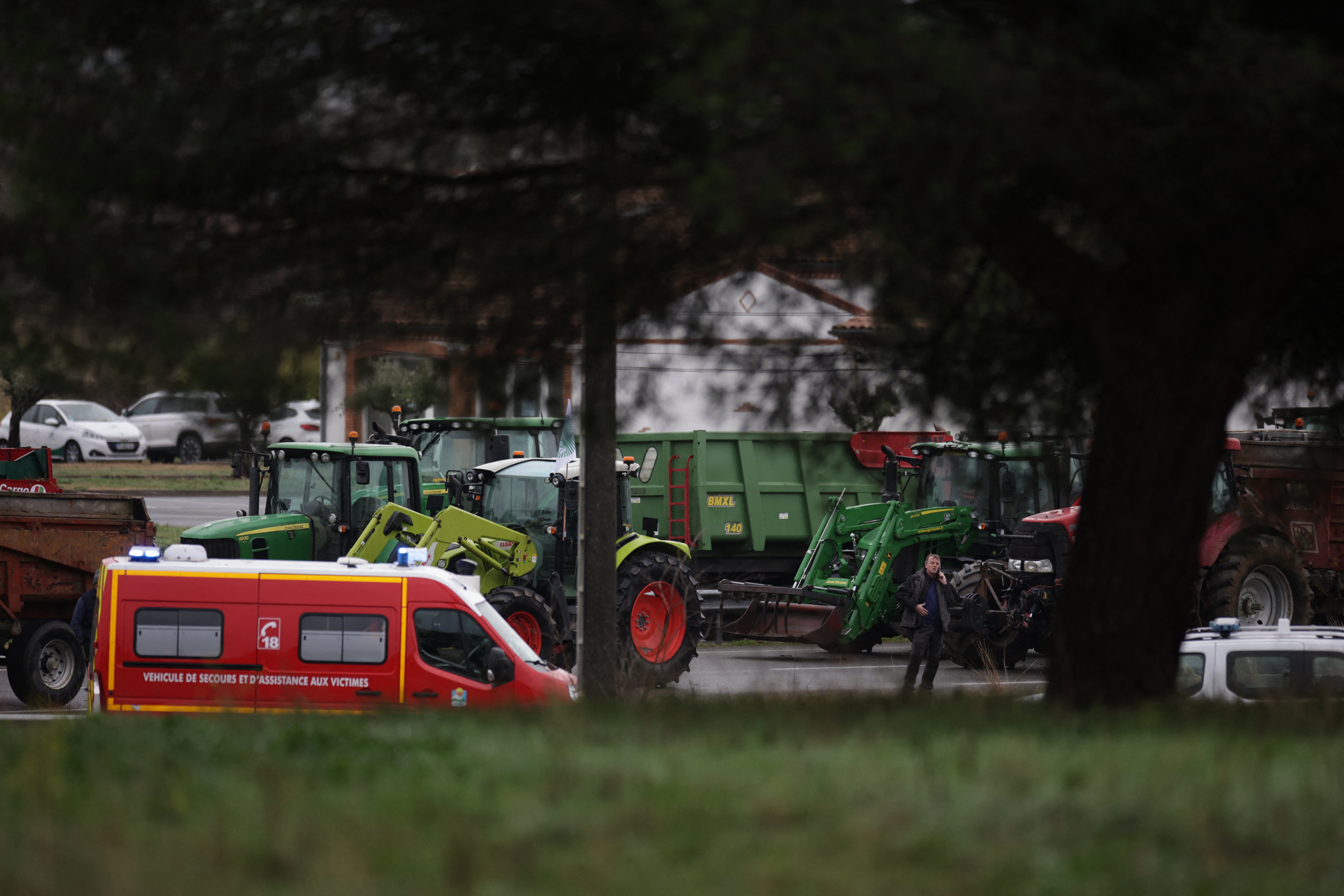 A firefighter vehicle is parked near the location where a farmer was killed