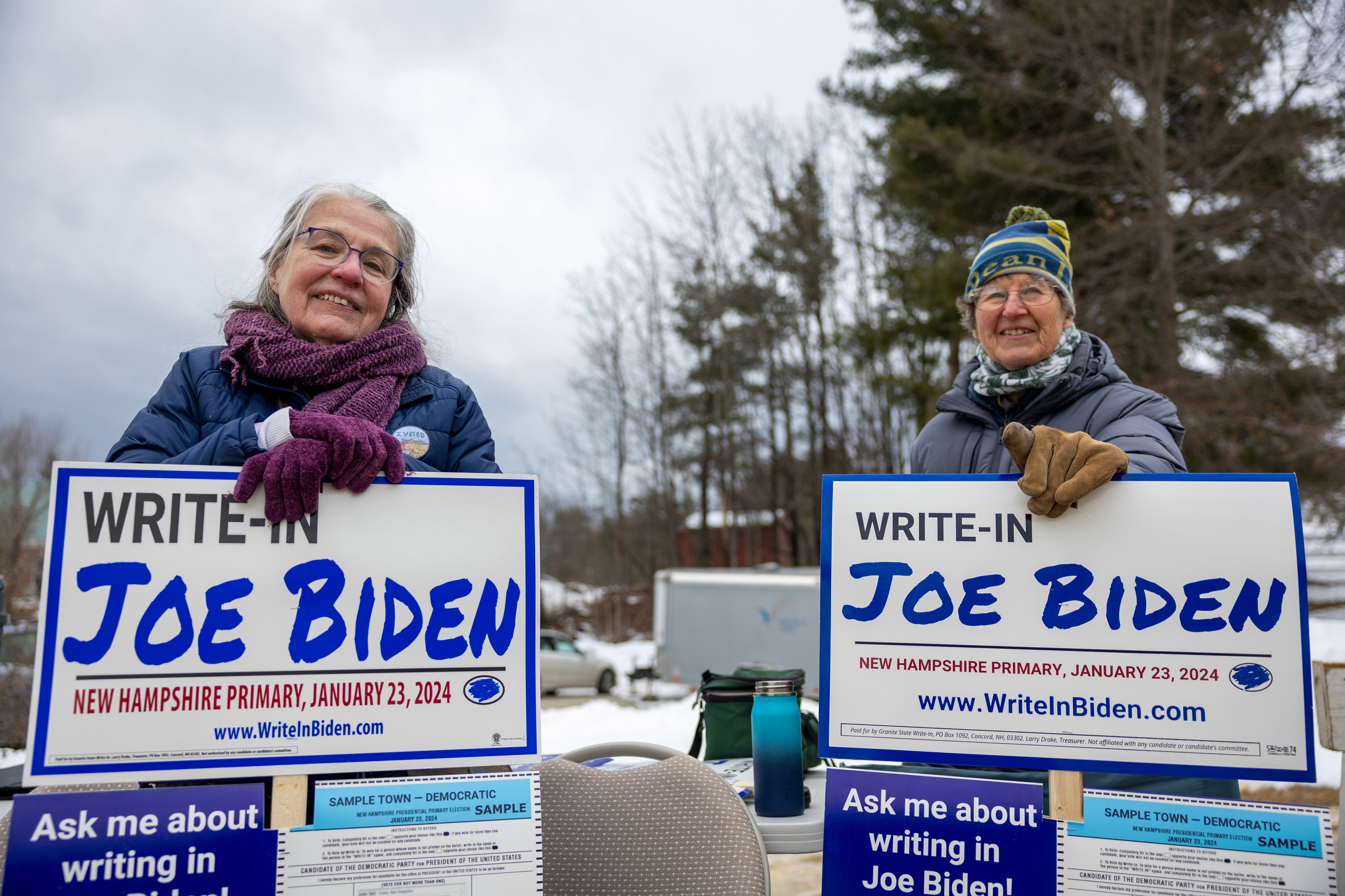 Supporters of President Joe Biden greet voters in Loudon, New Hampshire