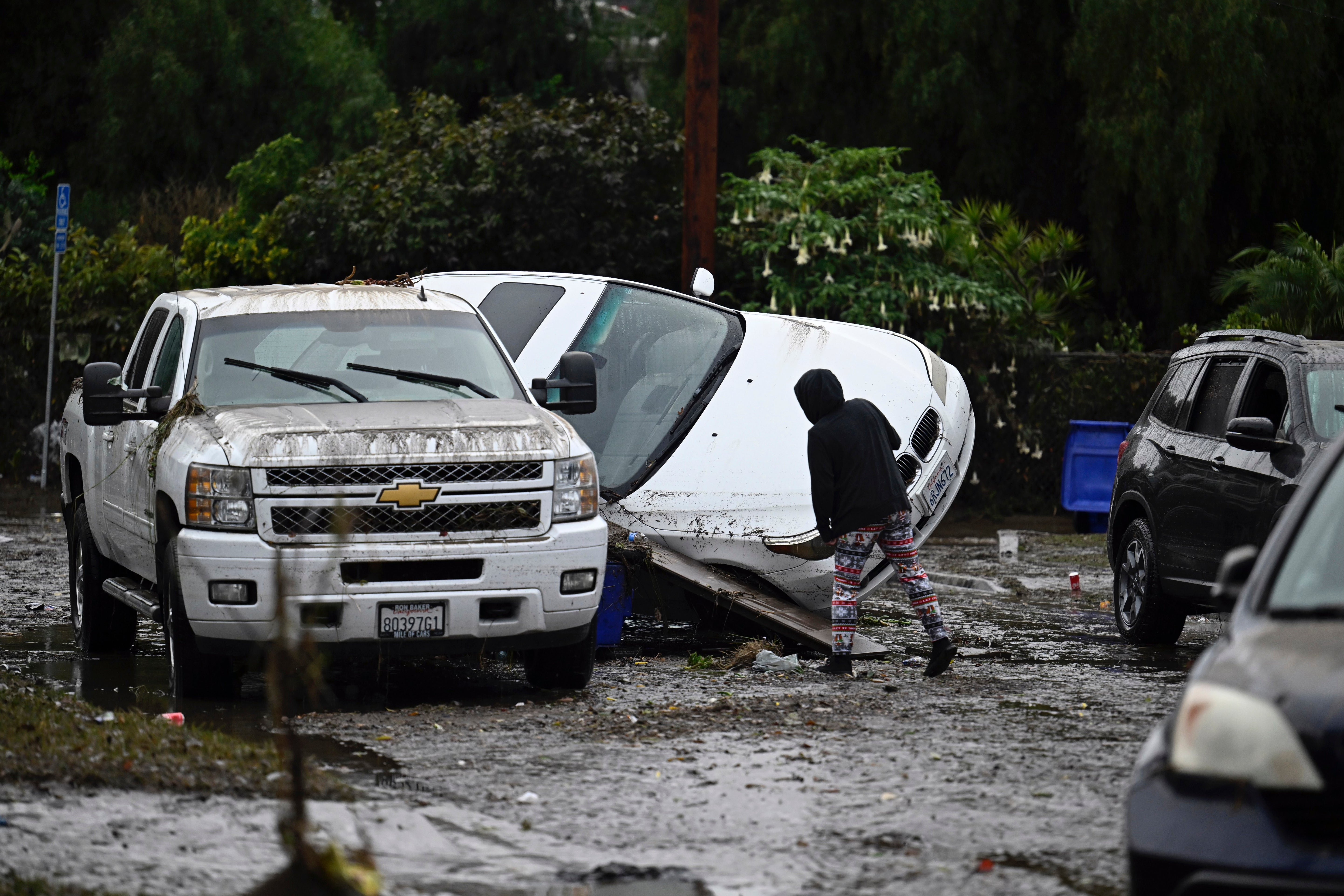 The flooding in San Diego earlier this week left cars like these damaged and homes wrecked.