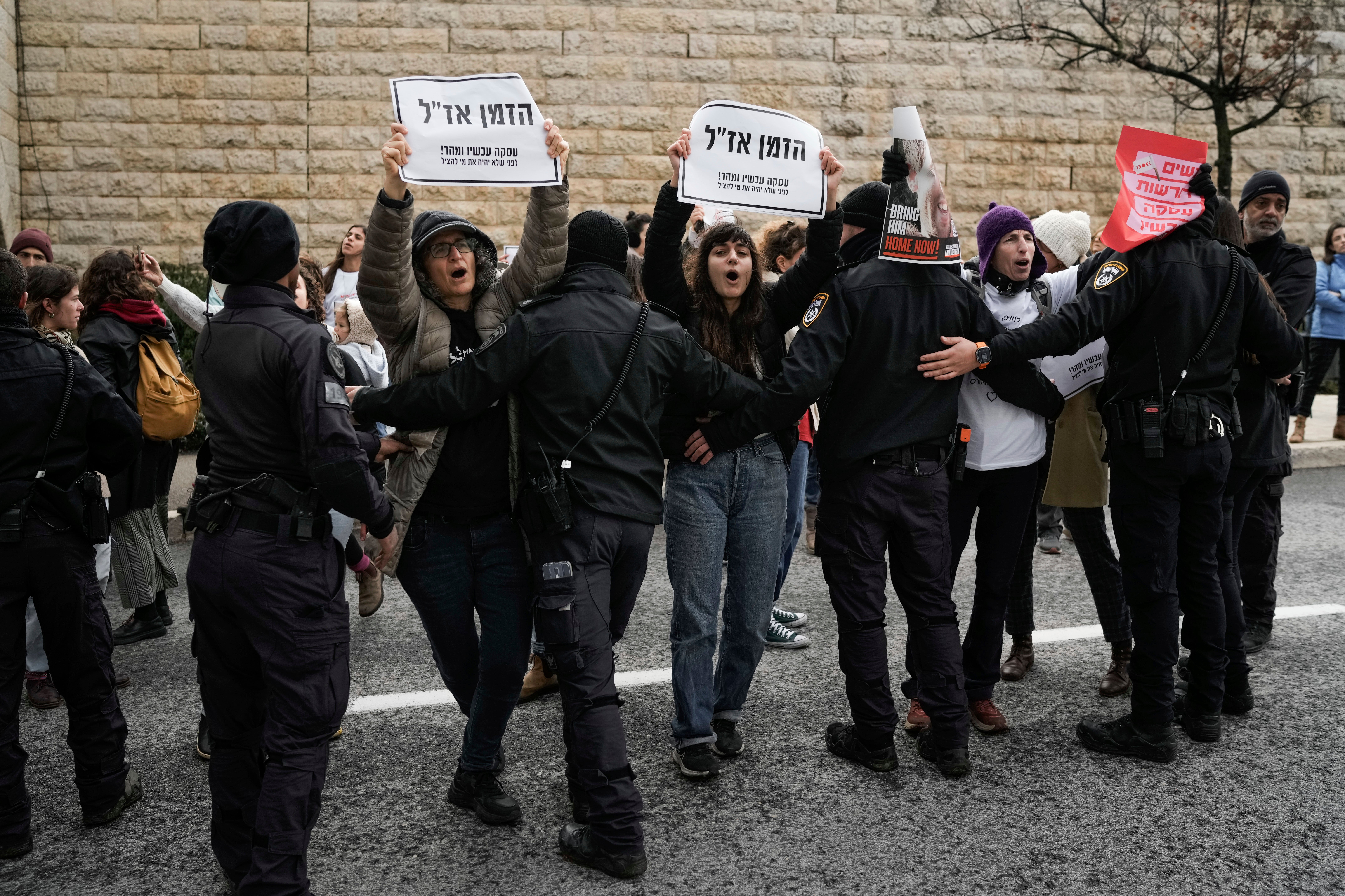 Israeli women hold banners that read ‘Time is running out’ as they demand the immediate release of the Israeli hostages held in Gaza