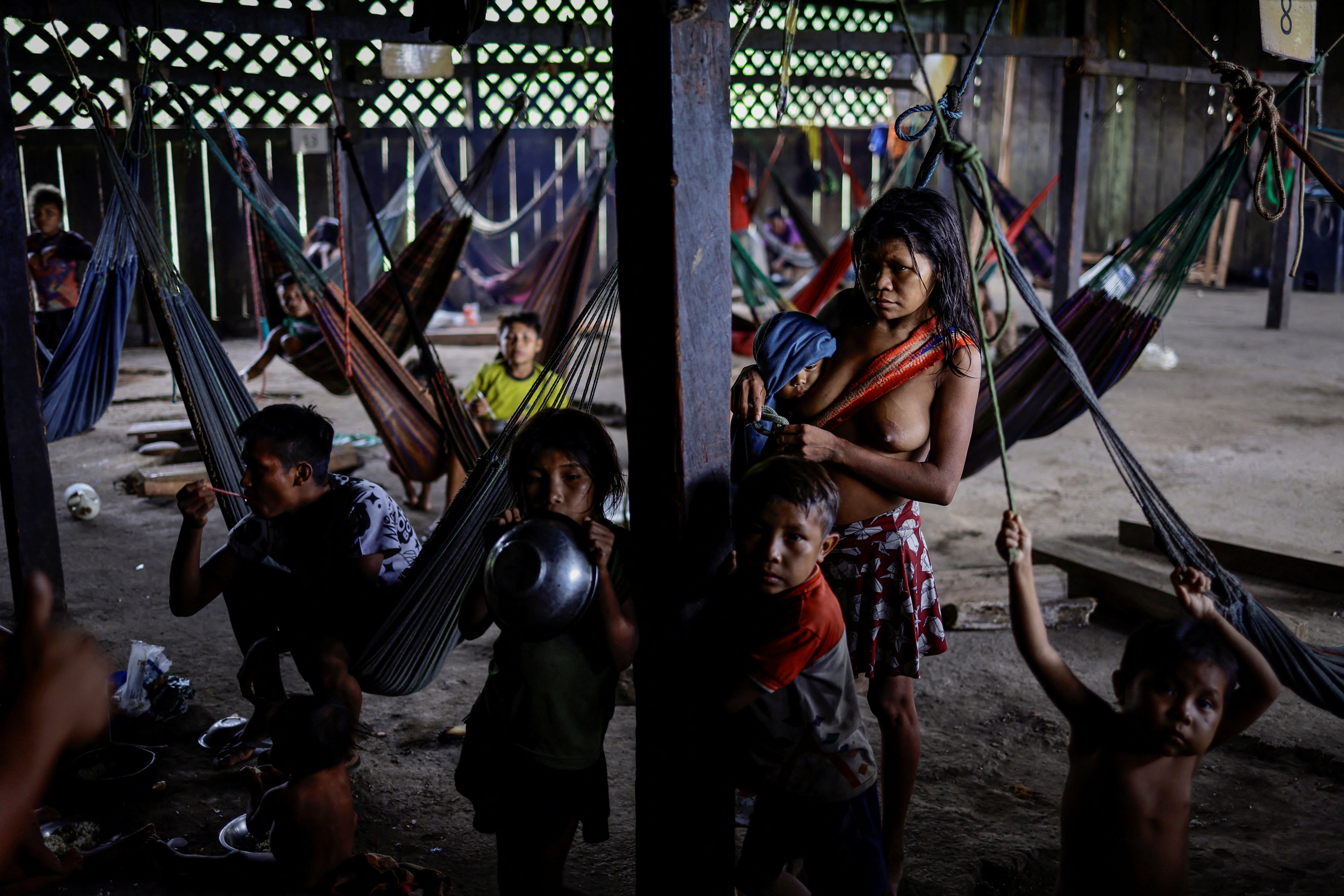 An Indigenous family receives food and healthcare at the Auaris Base Hub