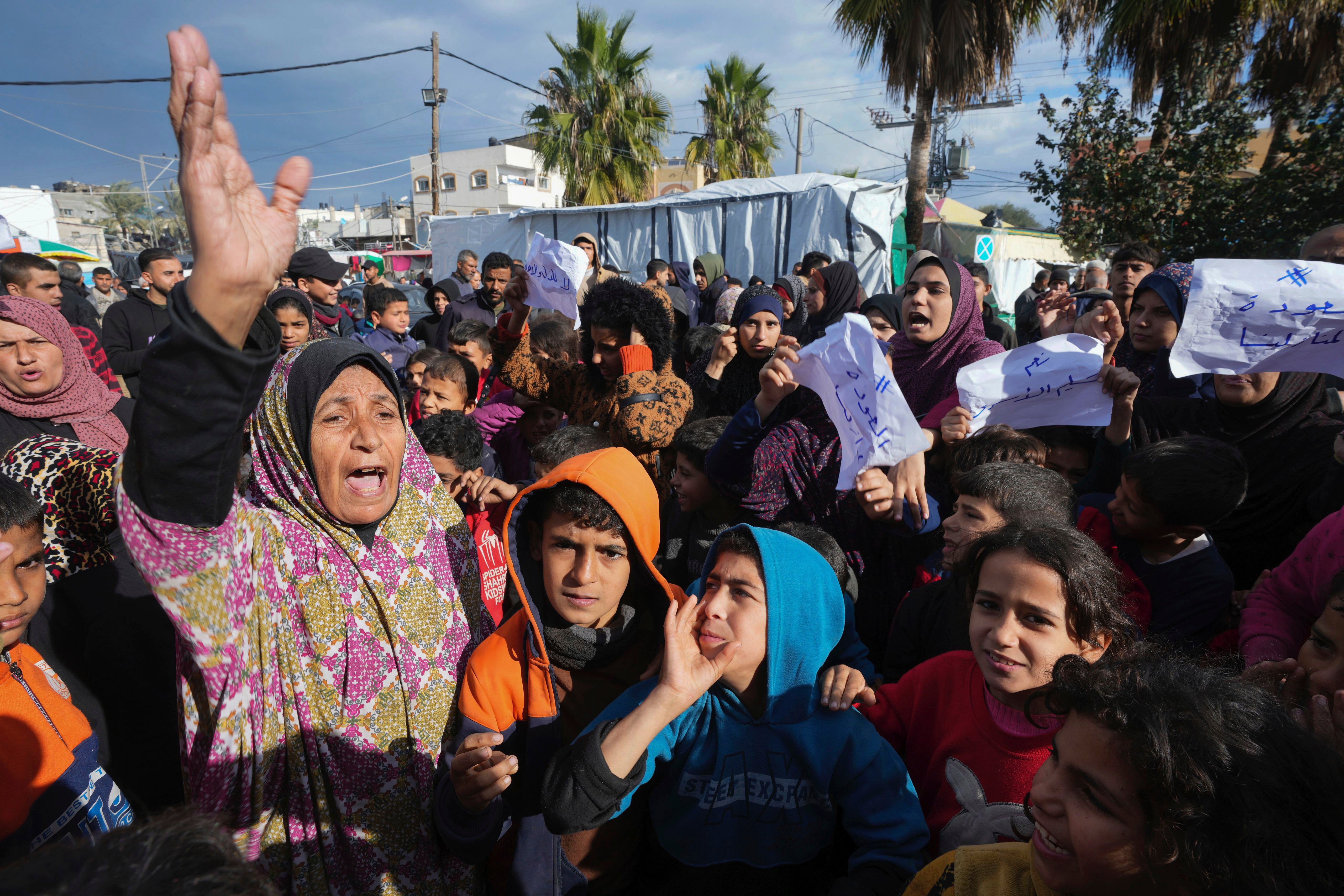 Palestinians demand an end to the war with Israel and call for the release of Israeli hostages held in Gaza by Hamas in Deir al Balah on 24 January