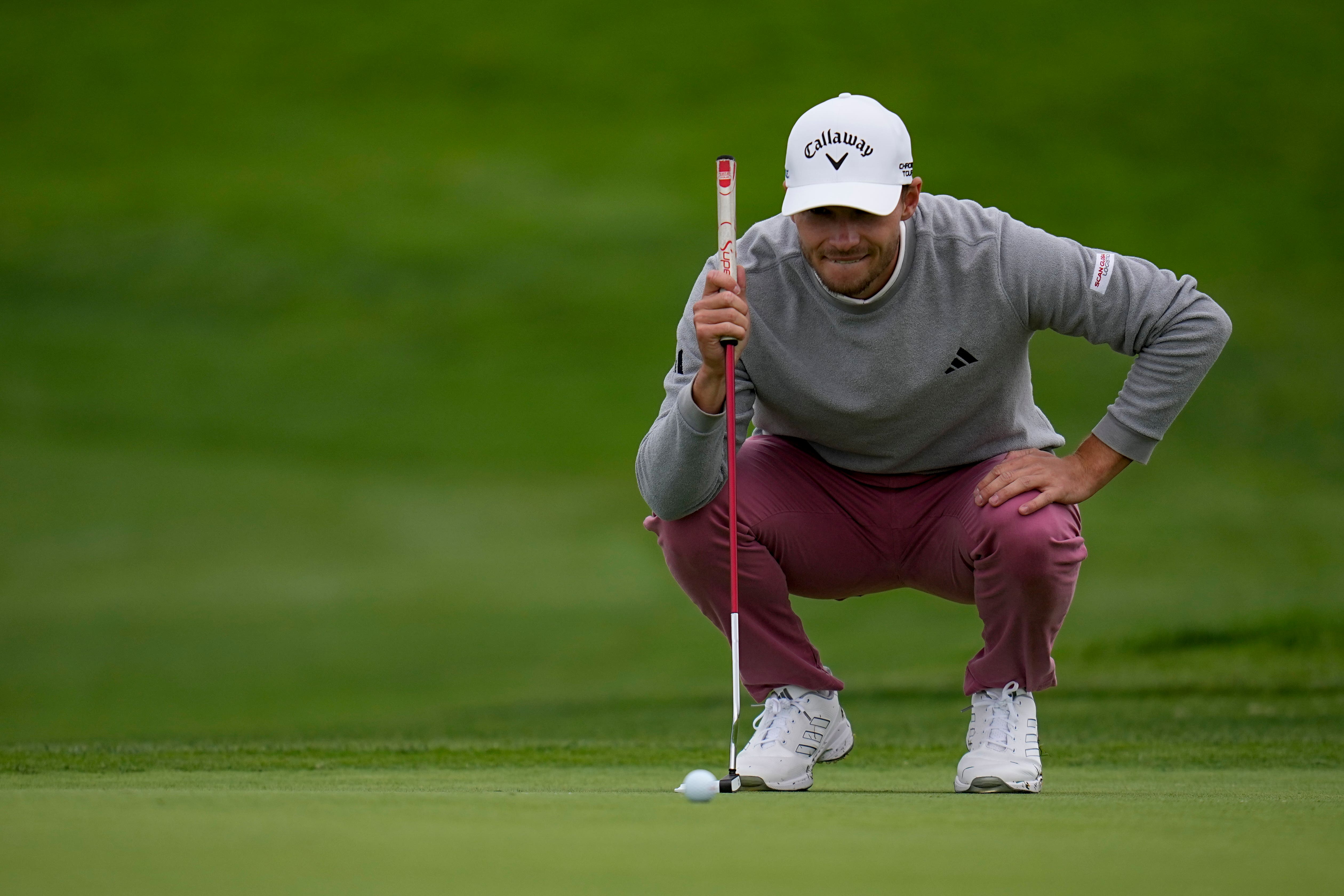 Nicolai Hojgaard looks over his putt on the second hole (Gregory Bull/AP)