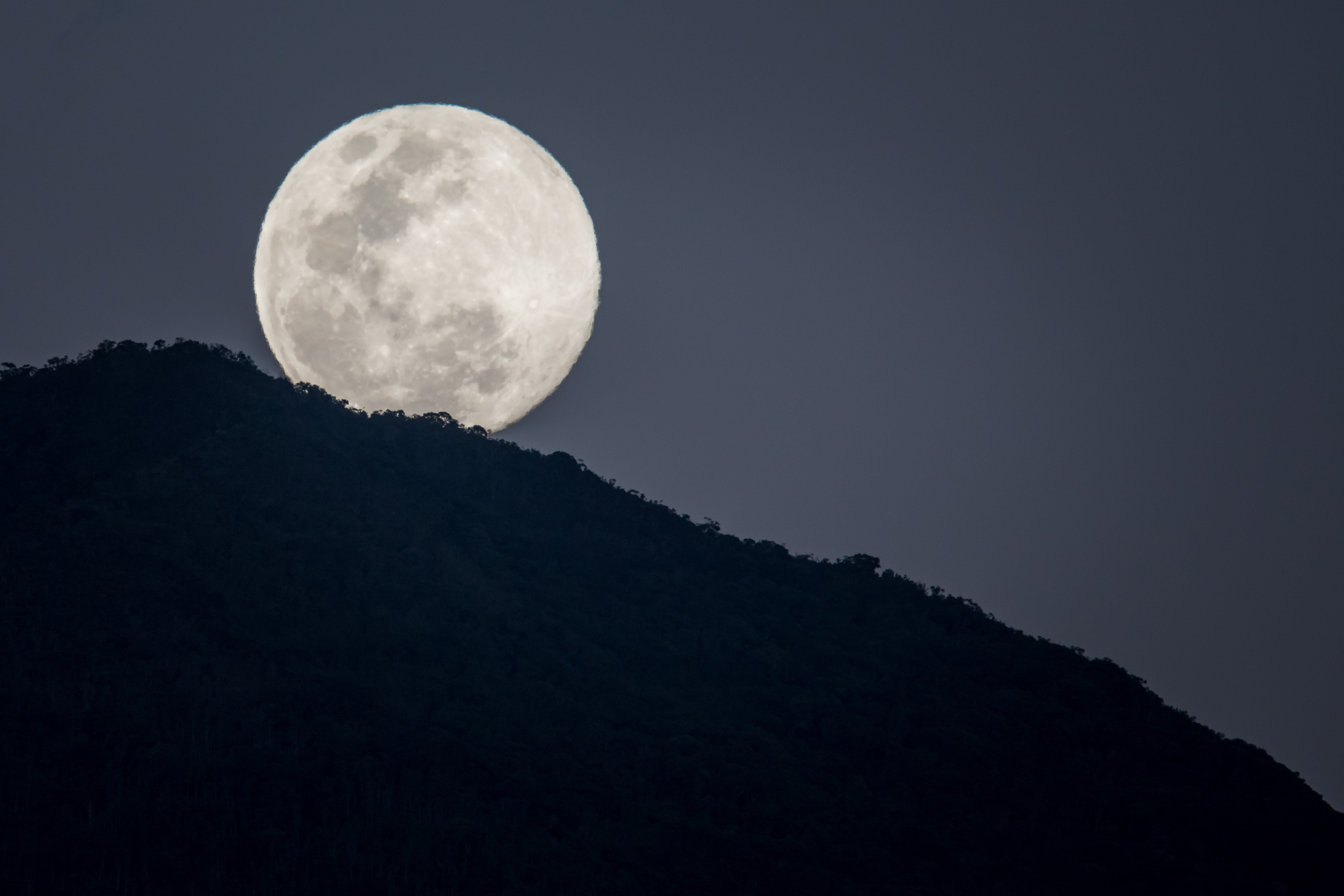 A full moon behind Waraira Repano National Park, in Caracas, Venezuela, in January 2024