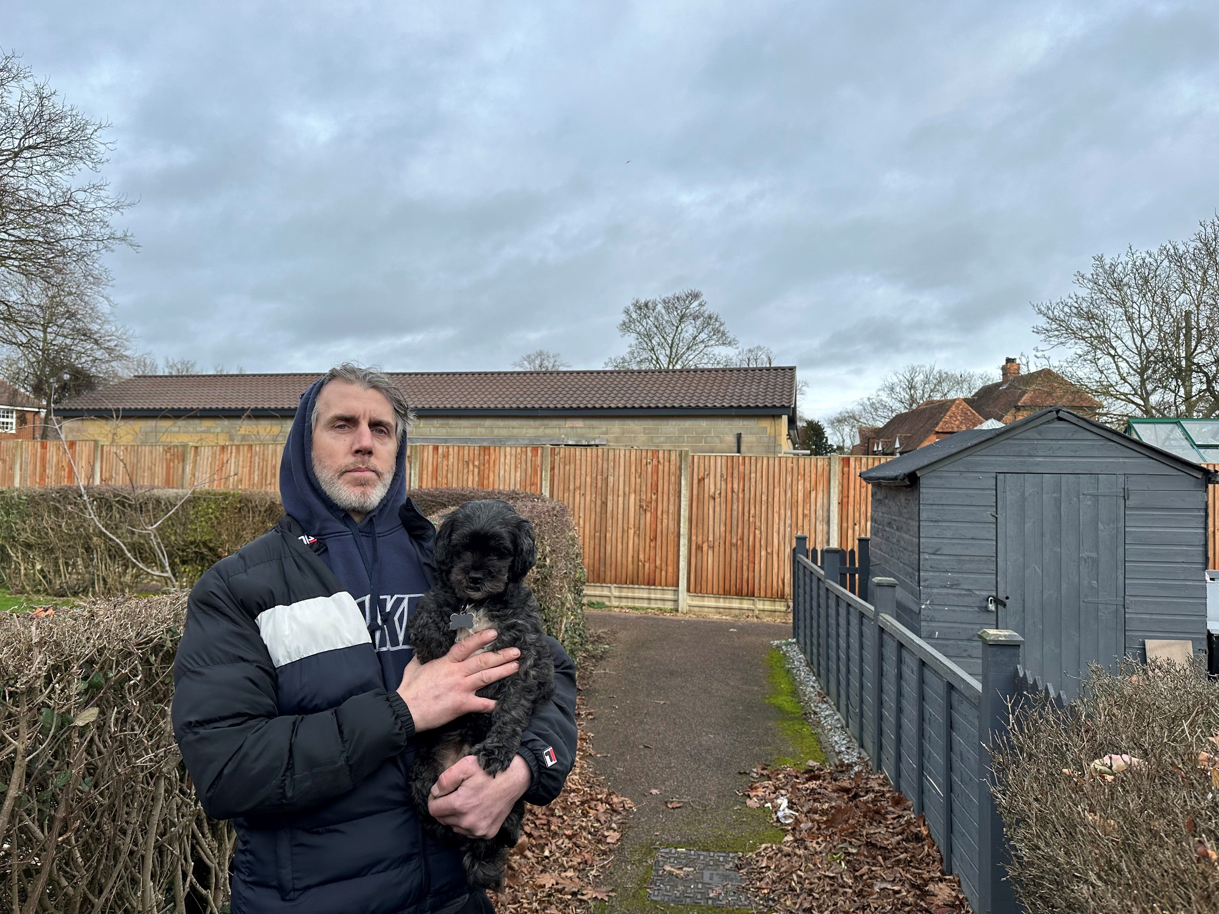 Villager Ian Knight, with the building behind him, says the situation has left Marston Mortaine to become a ‘laughing stock’