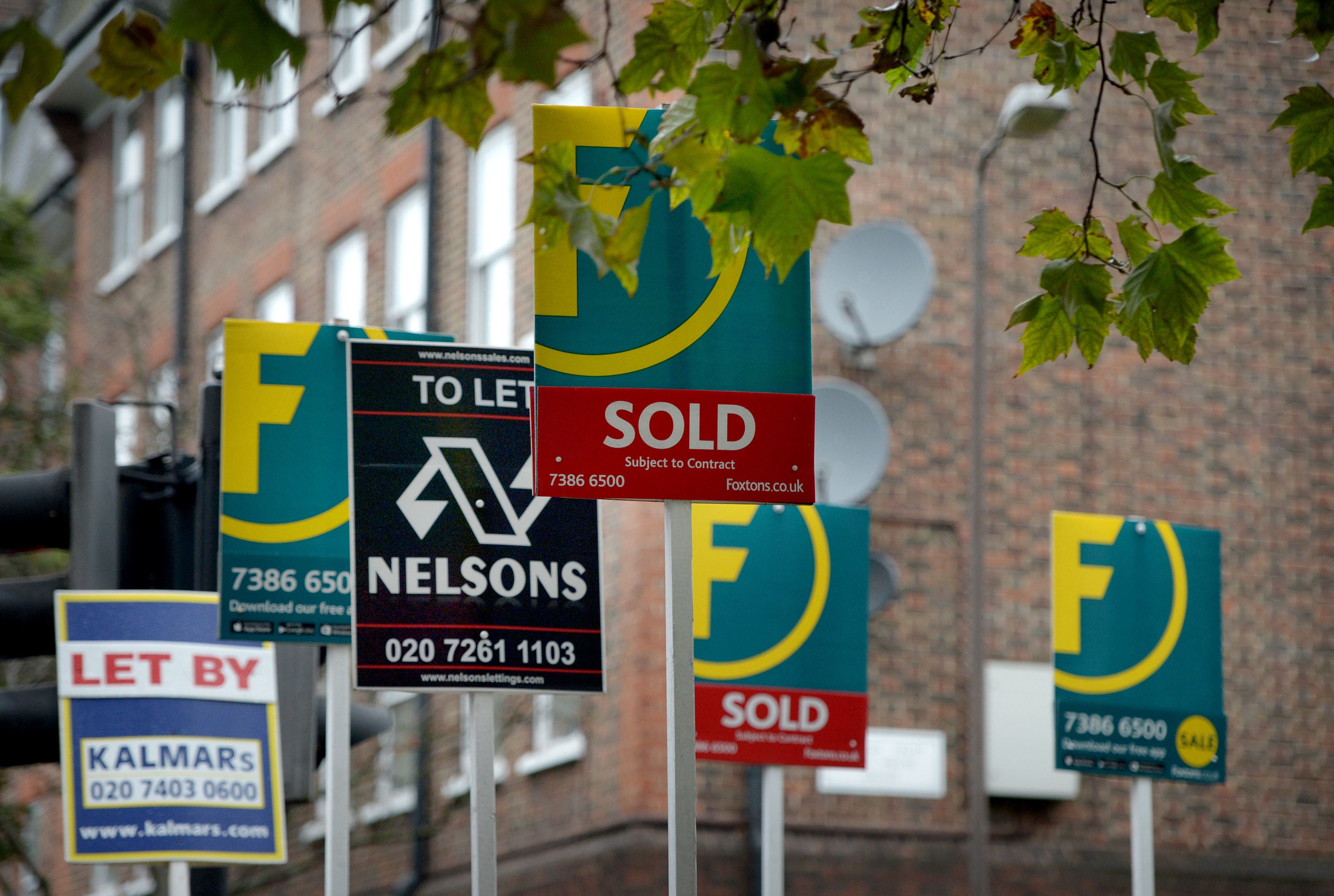 Letting and estate agents signs outside flats on the Old Kent Road in London