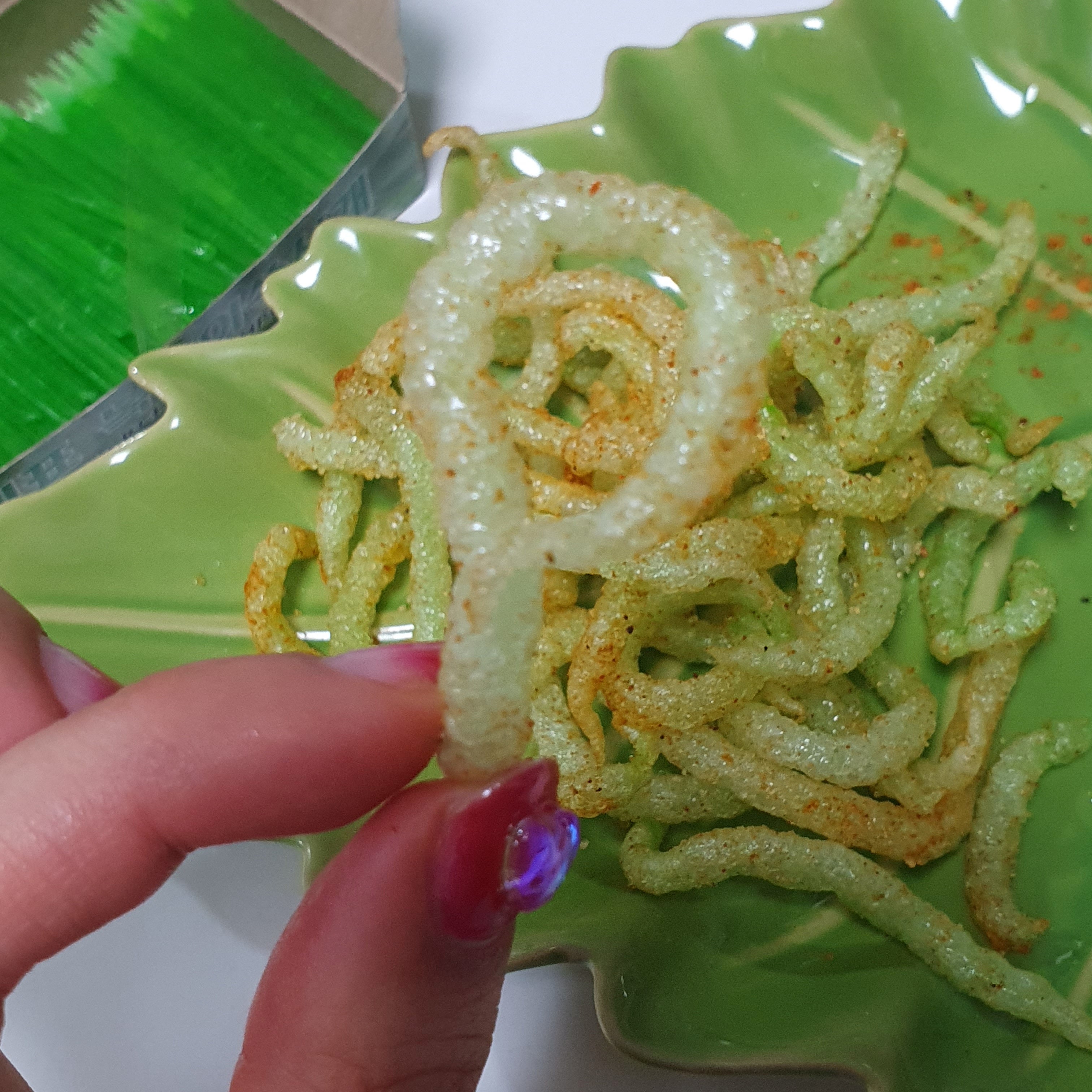 A person holds a "Fried green toothpick"