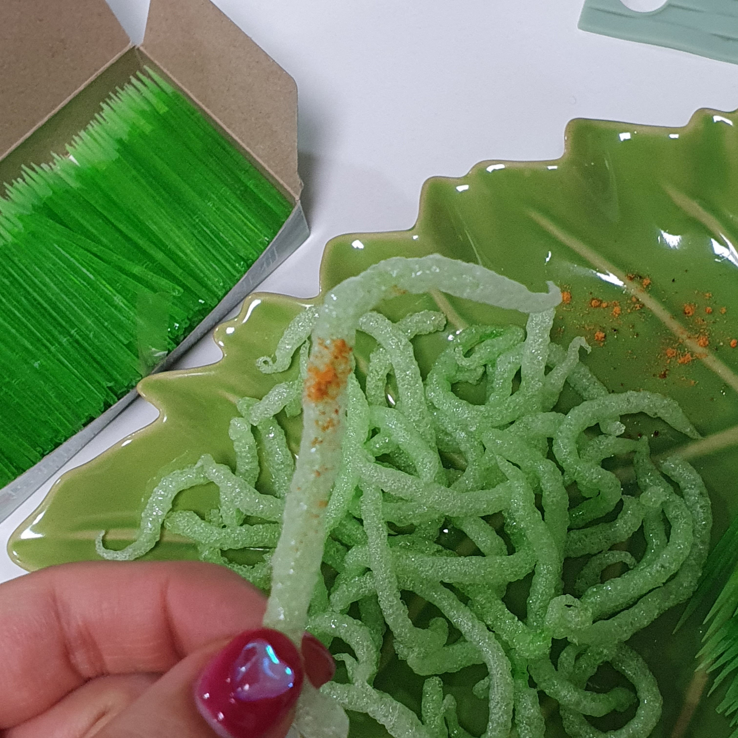 A person holds a fried green toothpick which went viral following a social media trend, against which South Korea's food and drug safety authorities have issued warnings