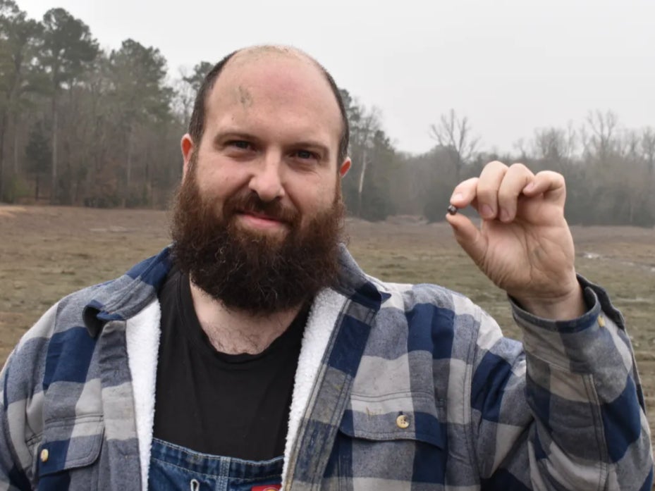 Julien Navas, of Paris, with the 7.46-carat diamond he found at Crater of Diamonds State Park in Arkansas