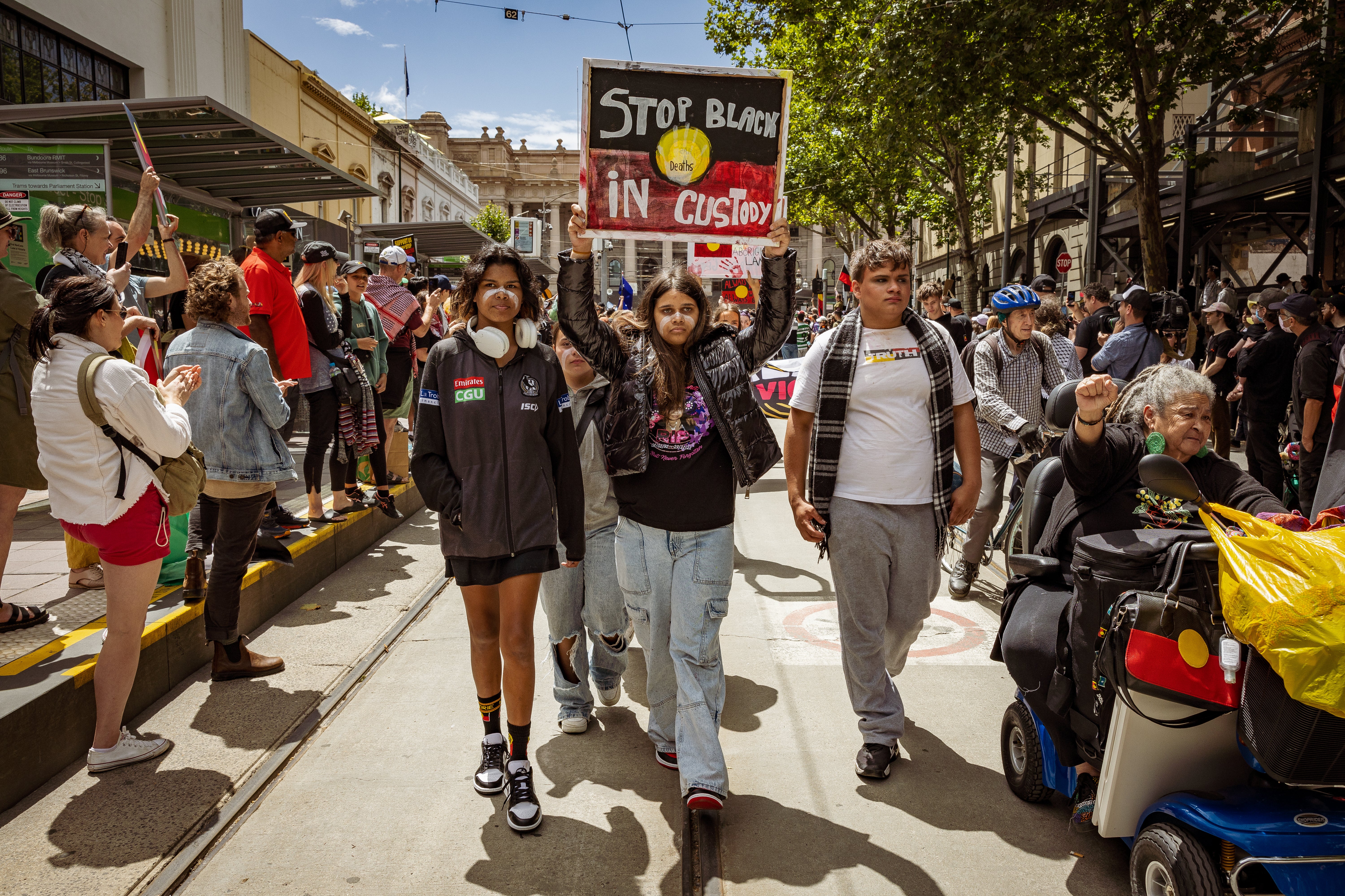 Aboriginal people carry a sign during the Invasion Day Rally