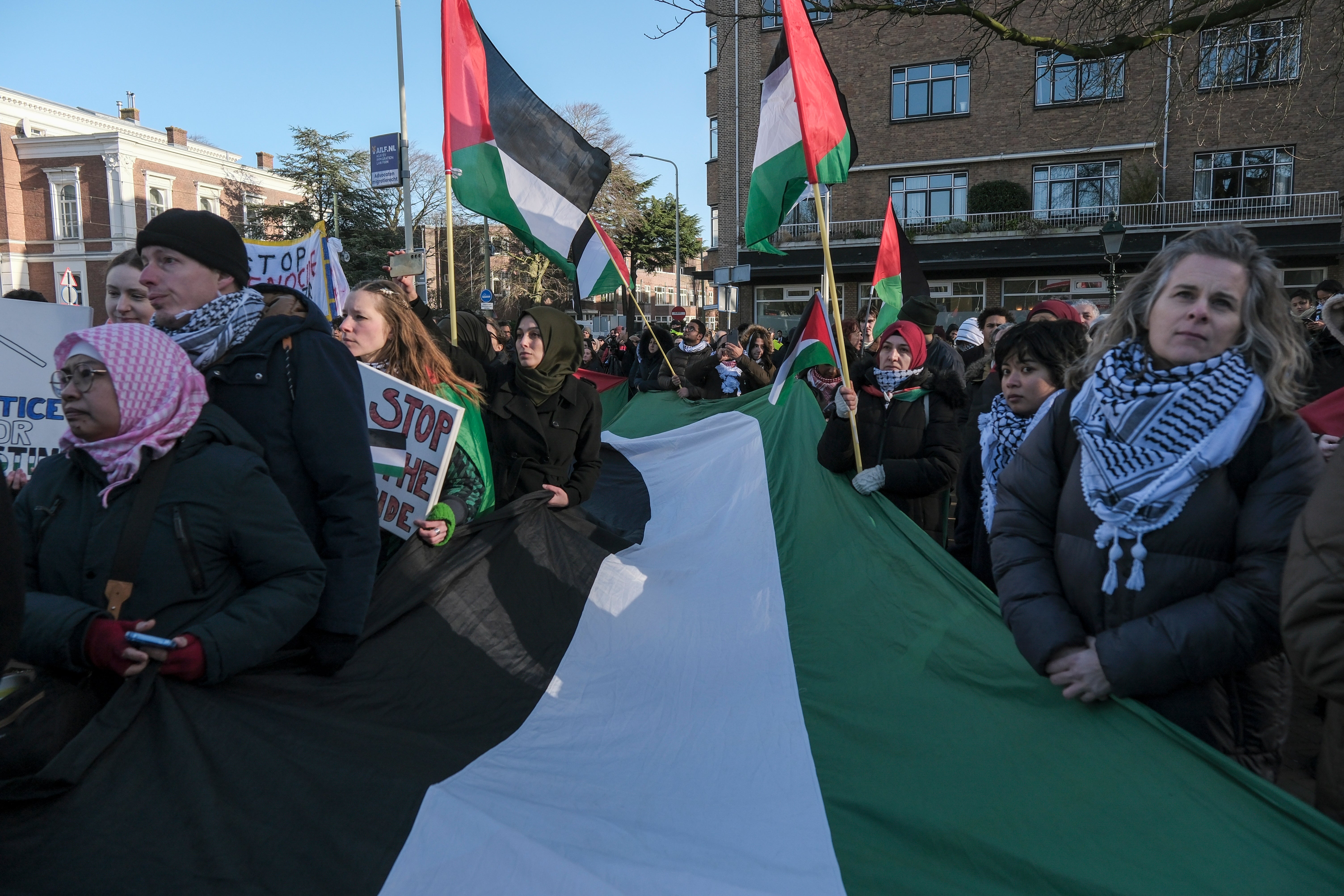 Pro-Palestinian activists gather during session of the International Court of Justice, or World Court, in The Hague, Netherlands, on Friday