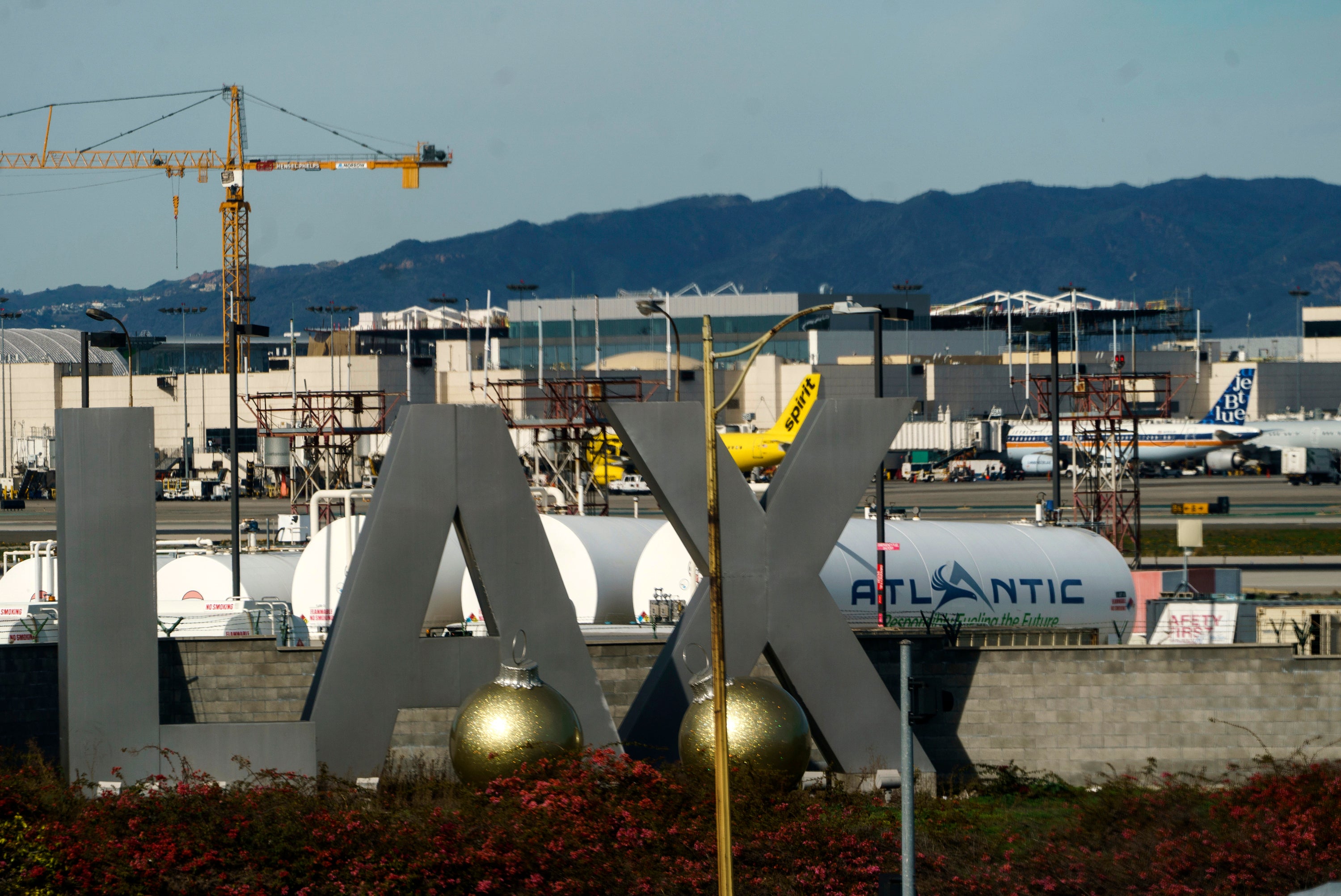 A shirtless passenger was seen sprinting across the tarmac at the Los Angeles airport and toward a plane.