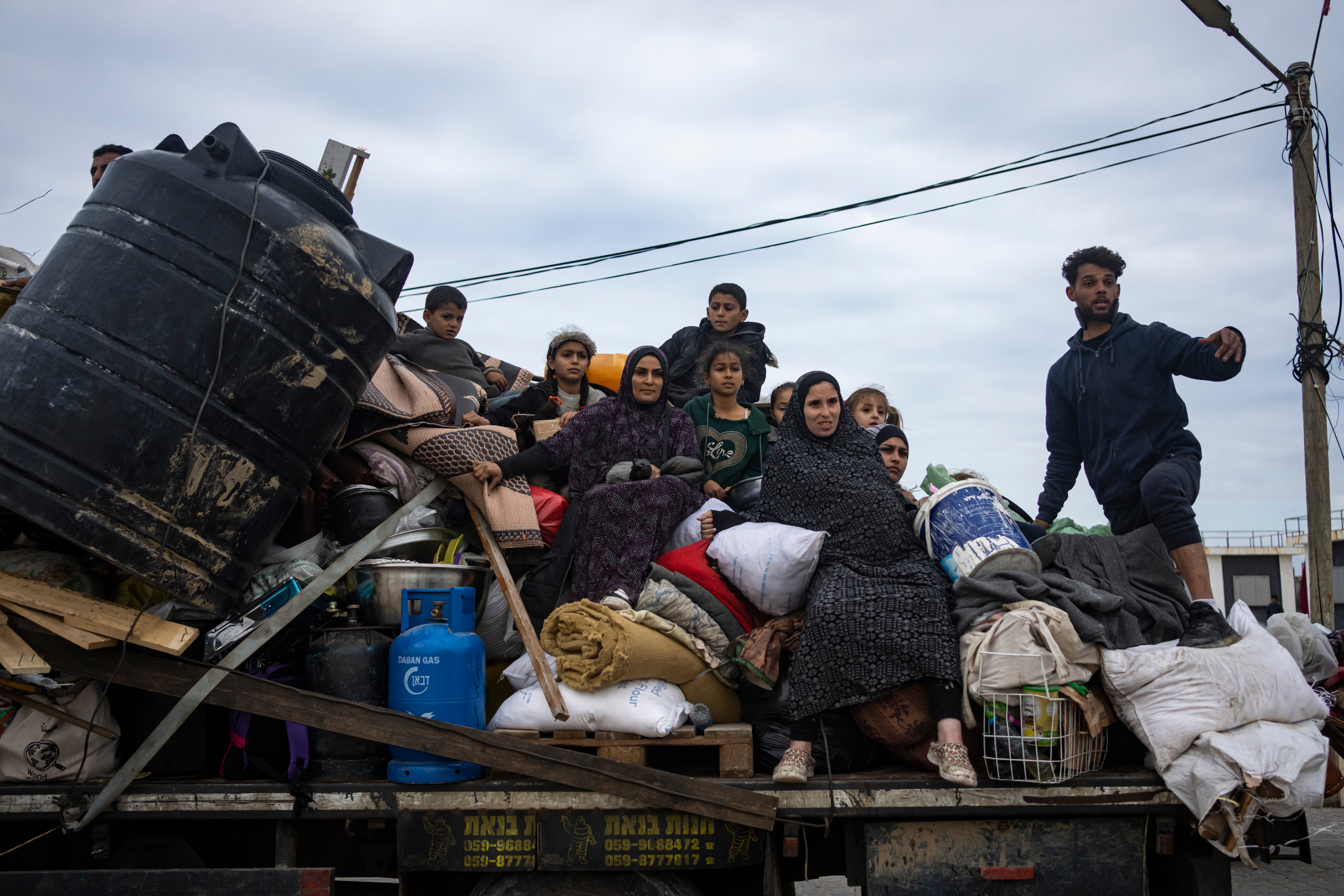 Palestinians arrive in Rafah after fleeing an Israeli ground and air offensive in the nearby city of Khan Younis on 26 January.