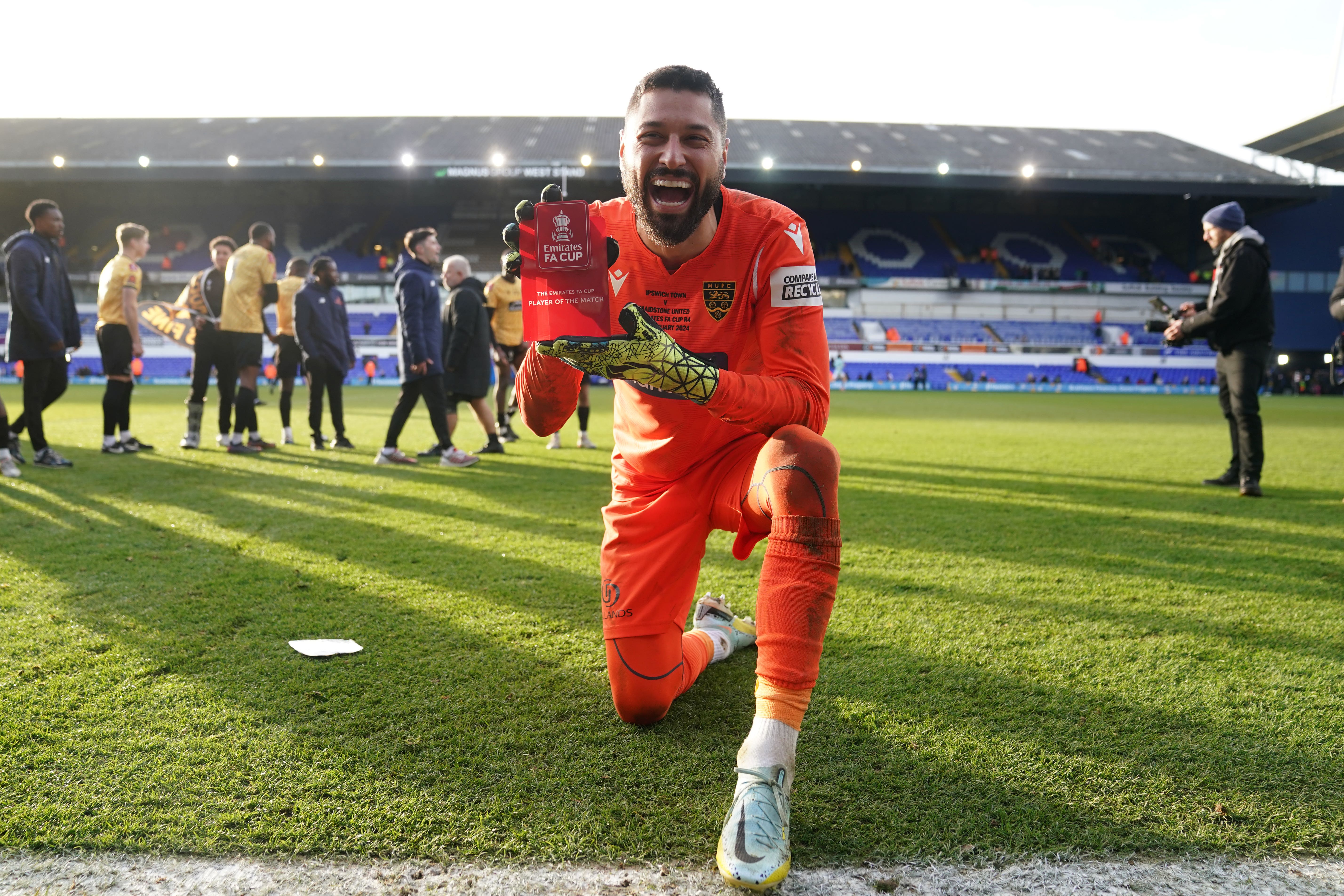 Lucas Covolan celebrates with the Man of the Match award after Maidstone’s 2-1 win at Ipswich (Joe Giddens/PA)