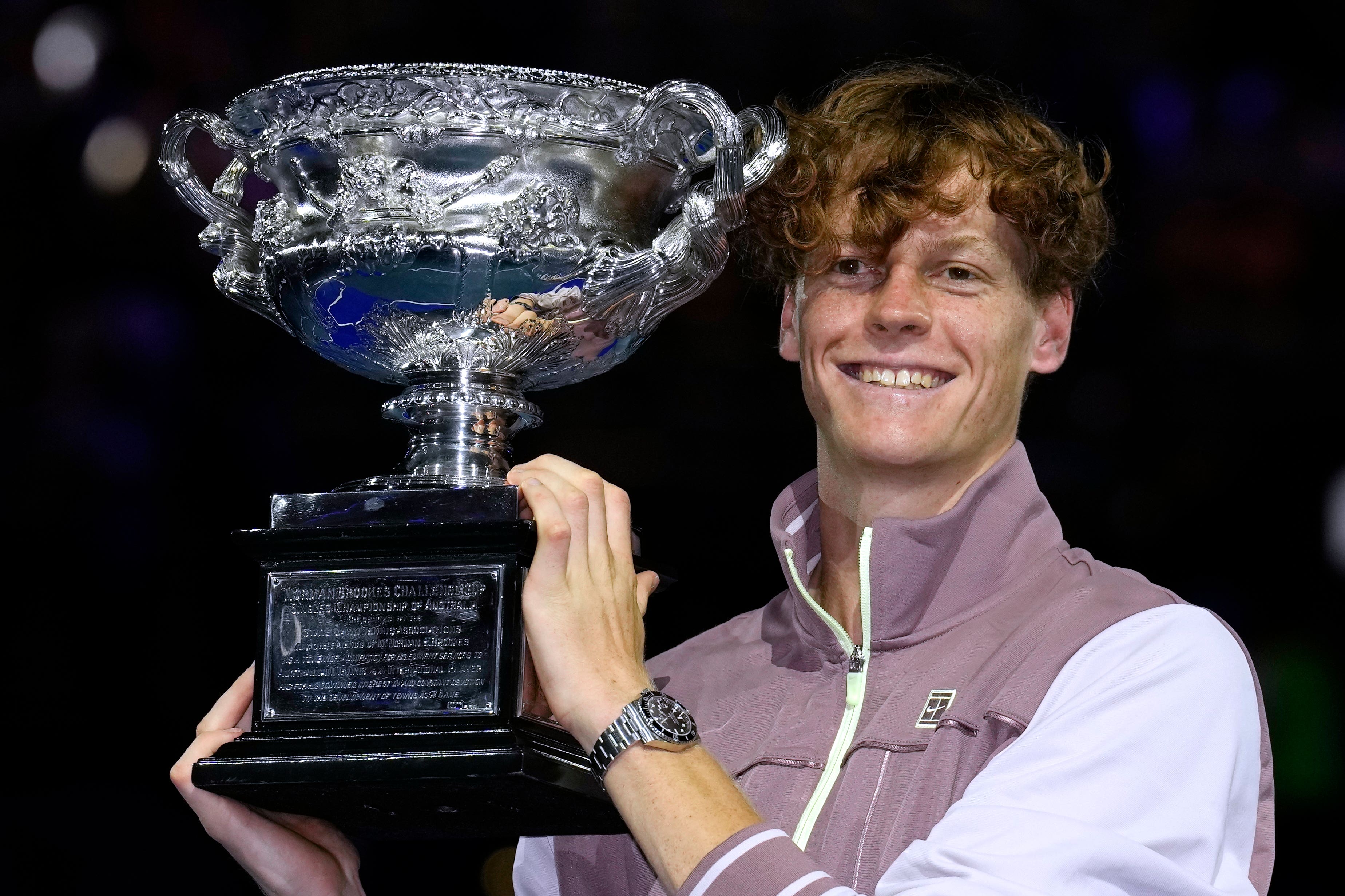 Jannik Sinner holds the Norman Brookes Challenge Cup (Andy Wong/AP)