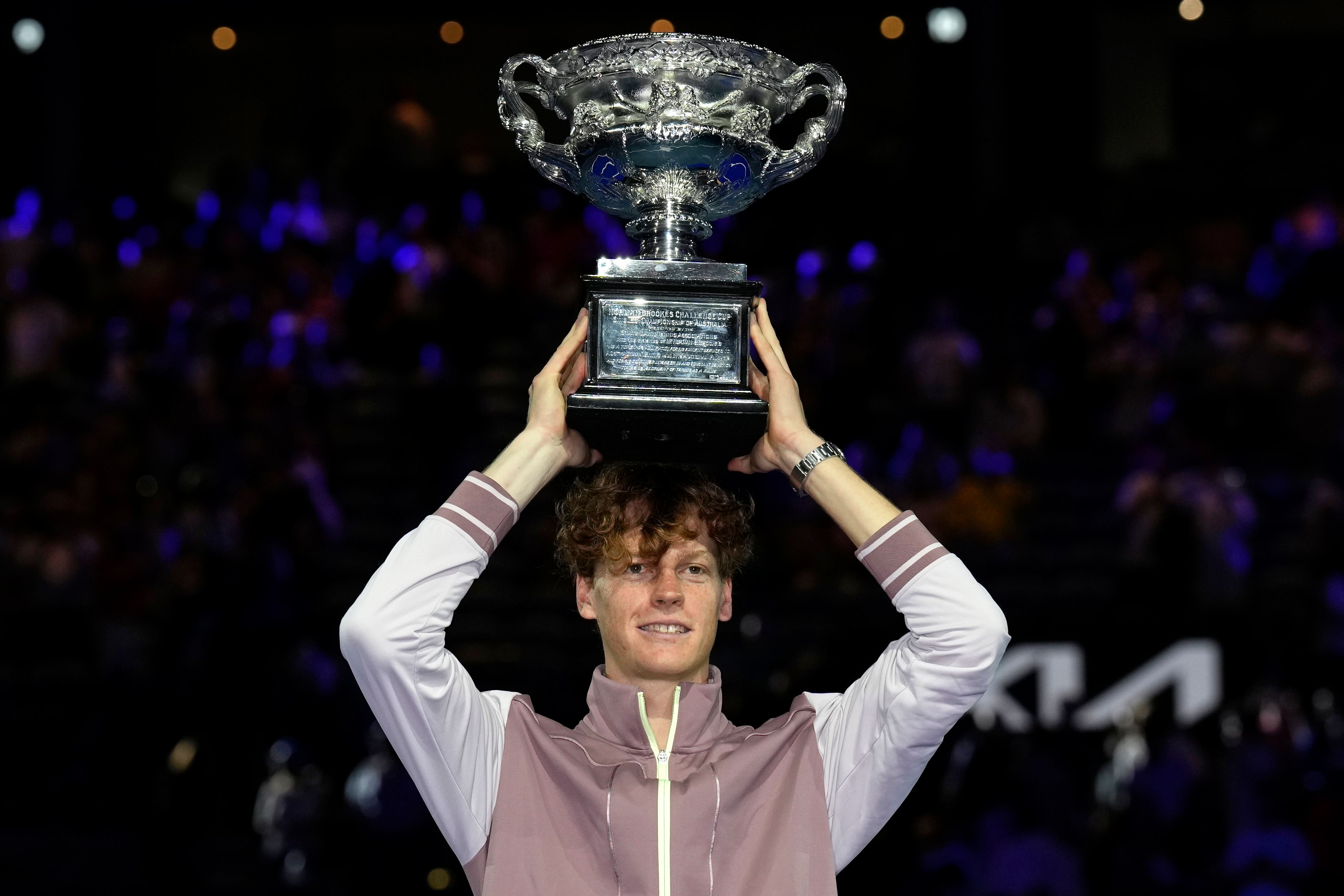 Jannik Sinner holds the Norman Brookes Challenge Cup (Andy Wong/AP)